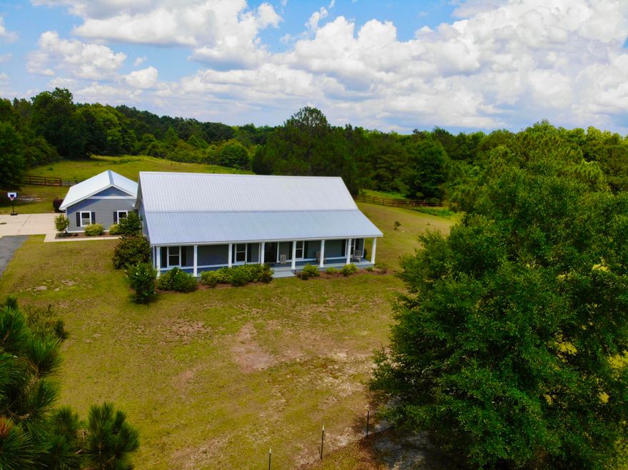 Like New spacious home sitting on 10.5 picturesque acres. The property is located on a paved road and has a paved driveway with electric gate. The open concept interior flows effortlessly onto the back porch making entertaining effortless throughout the 3,654 sq ft of total space that the home offers. The massive 3-car garage & workshop provides ample space for any projects that you find yourself doing. Seller has upgraded the home with a metal roof (2021), Trane HVAC (2021), Whole House Dehumidifier (2021), Eco Water Whole House Bottled Water-grade filtration system (2021), new interior paint, light fixtures, livestock fence, barn and large chicken coop, large concrete floor fully enclosed and covered chain linked dog kennel (2021). Schedule a showing today!