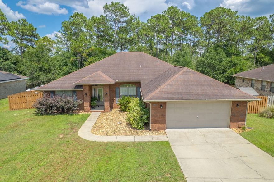 Imagine coming home to this Spacious 4-Bedroom, 3-Bath All-Brick Home in Desirable Alicia Place. This beautifully designed home with a 2-car garage is perfectly situated in the highly sought-after Alicia Place community, south of I-10--offering a quick commute to 7th Group, Duke Field, and Eglin AFB. From the moment you step onto the welcoming covered front porch, you'll feel the inviting warmth and charm this home offers. Inside, you'll find soaring 10-foot ceilings and an open-concept layout that blends comfort and style--ideal for both everyday living and entertaining. Enjoy hosting weekend get-togethers on the back patio while sitting by the fire pit  or preparing meals in the chef-inspired kitchen. FEATURING Stainless Steel Appliances, ample cabinet space, a walk-in pantry, and a breakfast bar perfect for casual mornings. A flex room provides a versatile space that can be used as a home office, playroom, or a second living areacustomized to fit your lifestyle. The split-bedroom floor plan maximizes space and privacy, offering a huge master suite with a spacious ensuite bath, and three additional generously sized bedrooms. Thoughtful touches throughout the home include wood-look tile flooring, abundant storage, and architectural details that set it apart from typical builder-grade homes. The tumbled brick exterior and refined design create a timeless look that's both durable and elegant. This is more than just a houseit's a home your family can enjoy for generations.