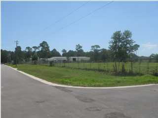 Nice level land mostly cleared that backs up to Hurlburt Air Force Base. Property is fenced. Zoned M-1 Industrial in the City limits of Fort Walton Beach. Great location for office/warehouse development.