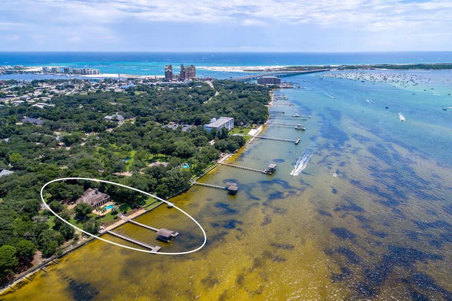 NEW PRICE + $50,000 rebate toward updates. A RARE OPPORTUNITY: prestigious home on Destin's most cherished waterfront. Very few homes can offer a bayfront view of the turquoise waters of Crab Island and surroundings. This property was among those first treasured by Destin's earliest settlers, not just for its incredible sunset views but for the bounty of fish and shellfish that can be found at the end of its dock. For those who want to be able to walk out their back door, go aboard their boat and be in the Gulf of Mexico in minutes, this property is one of the very few that can satisfy them. This home defines the Florida lifestyle that so many can only dream about.