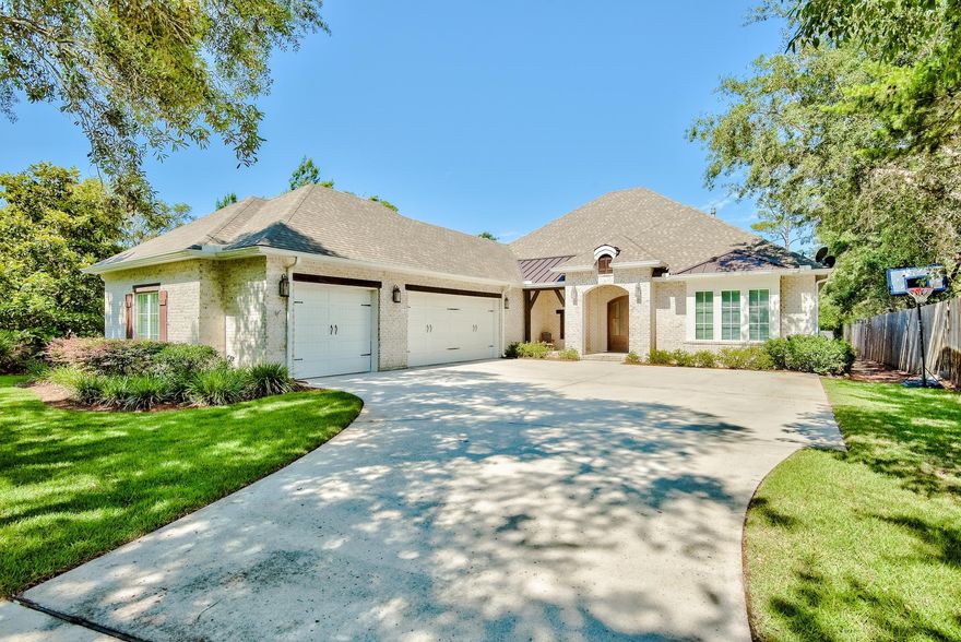 Phenomenal bayou front home situated on an expansive lot offering just over half an acre of true privacy. There is beautiful curb appeal with lush surroundings and covered front porch accented with wooden beams and entry doors. This 4-bedroom home has custom details throughout setting it apart from the rest. Upon entering the home, you are greeted in the beautiful foyer with raised ceilings and hardwood floors throughout. The living area features a stunning coffered ceiling with recessed lighting, a fireplace accented with shiplap and built-in shelving, and large sliding glass doors that offer plenty of natural light and direct access to the covered lanai and screened-in pool area. The covered lanai is great for entertaining and offers a fireplace, large flat screen TV, and summer kitchen.