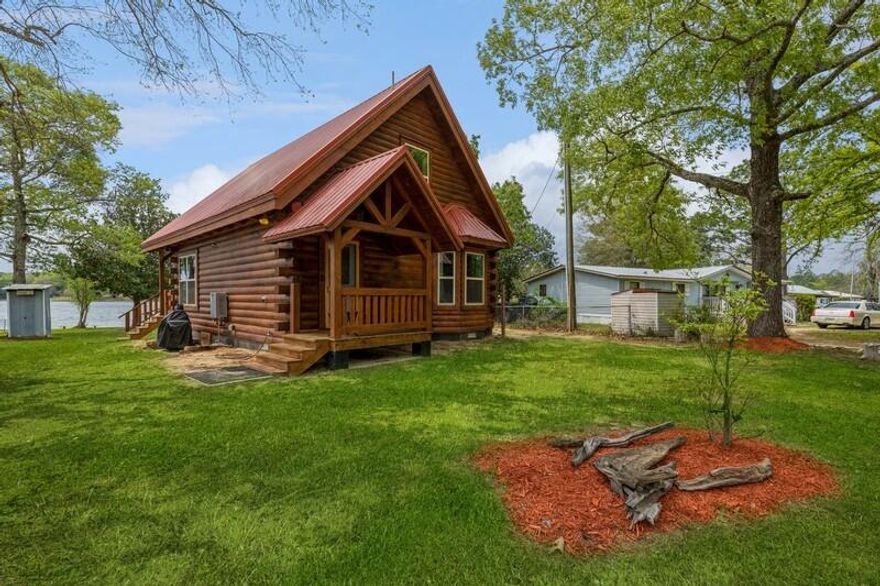 This beautiful Cabin is a dream come true ! The cabin was built in 2021 and is located on Kings lake. The lake is a Fishermans paradise and the sunsets are simply amazing. The home is made with Eastern White Pine logs. The kitchen counters,  bathroom counters and shelves are sinker cypress. The living room ceilings are 22' high. The tempered glass windows are argon filled. Outside you will find an outhouse and 2 RV hooks ups with a 30 amp box. You will also find a 10x16 workshop/shed with an 100 amp box . There is a covered deck along with a fish cleanings station , double sink with fresh water and a boat slip . The home has central air and heat. There is a propane gas fireplace and the home comes equipped with security cameras.