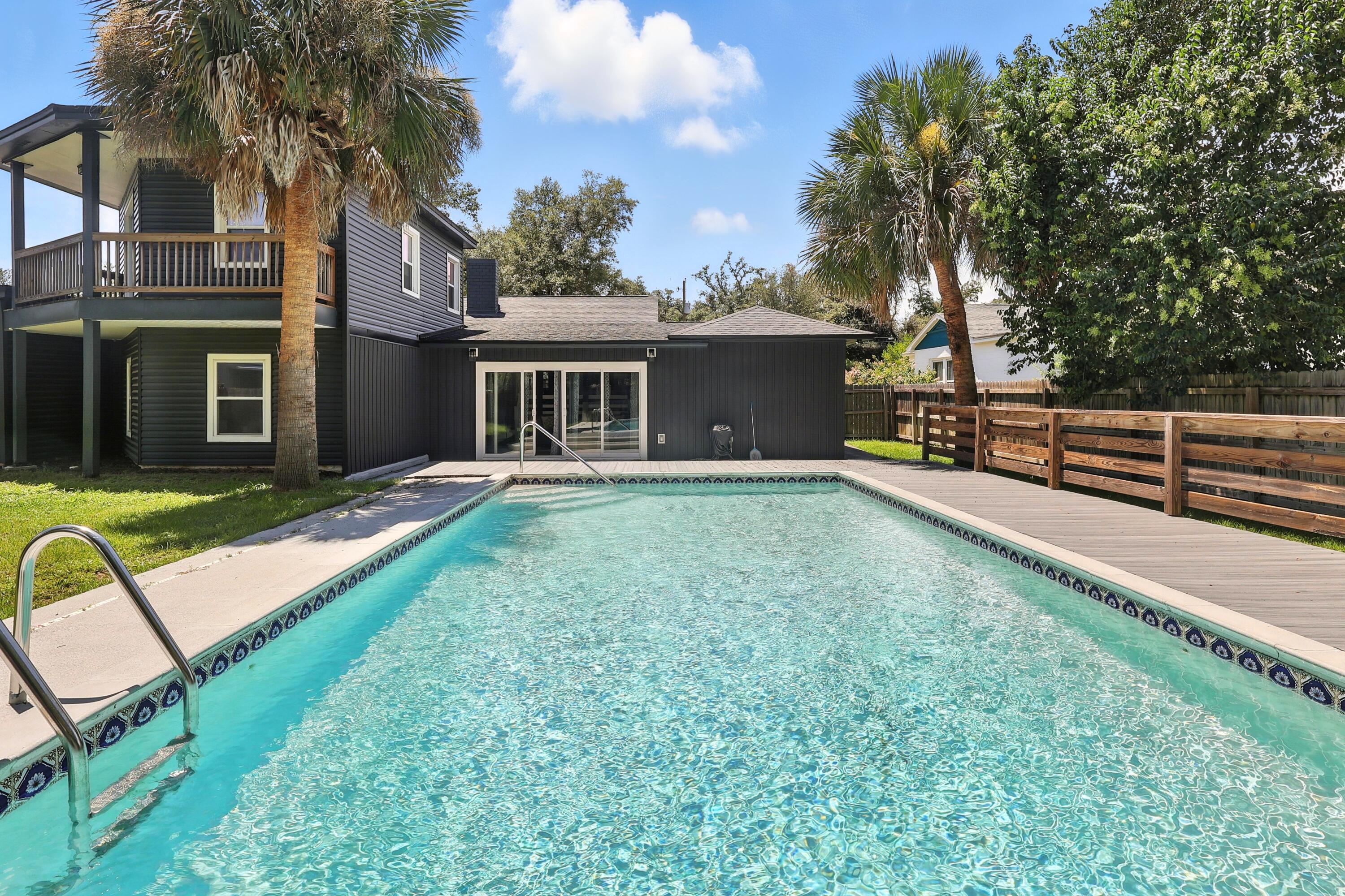 Wow! This absolutely stunning POOL HOME in the desirable Bunkers Cove has been masterfully and COMPLETELY RENOVATED from top to bottom. The inviting front porch welcomes you into the front sitting room - where the charming fireplace and stylish decor immediately set a tone of warmth and luxury. Quartz countertops and stainless steel appliances highlight the gleaming kitchen while sleek vinyl plank flooring extends throughout the entire home - no carpet! With 4 bedrooms and 2.5 baths, the semi-open floor plan connects multiple living and flex spaces with endless possibilities. Whether you envision a dedicated home office, a hobby room, or a private home gym, this residence has the square footage and intelligent layout to accommodate your preferences. The primary suite is a true retreat. Its gorgeous en-suite bathroom features both a timeless clawfoot tub and a separate, beautifully tiled walk-in shower with frameless glass. The real game-changer is the massive walk-in closet, which includes its own private laundry hookup for convenience. Upstairs in the loft area, an additional spacious bedroom offers a private balcony overlooking the incredible backyard. The sparkling in-ground pool is framed by durable, low-maintenance Trex decking, which creates an expansive and impressive space designed for endless outdoor enjoyment. The spacious patio offers ample room for grilling and hosting, all within the fully-fenced yard that provides privacy plus convenient back alley access. This property offers more than just cosmetic beauty; it provides true peace of mind. The renovations were not just an aesthetic refresh, but a comprehensive update with key systems upgraded, including the 2019 roof, two high-efficiency HVAC systems, two water heaters (one tankless), new siding, new windows, fully updated electrical and plumbing, plus energy-saving spray foam insulation. To complete this truly turnkey experience, the home is expertly furnished, with all furnishings negotiable with the sale of the home. With its rare combination of size, style, and top-to-bottom renovation in an unbeatable Bunkers Cove location, this home truly has it all. Schedule your private showing today and prepare to fall in love!