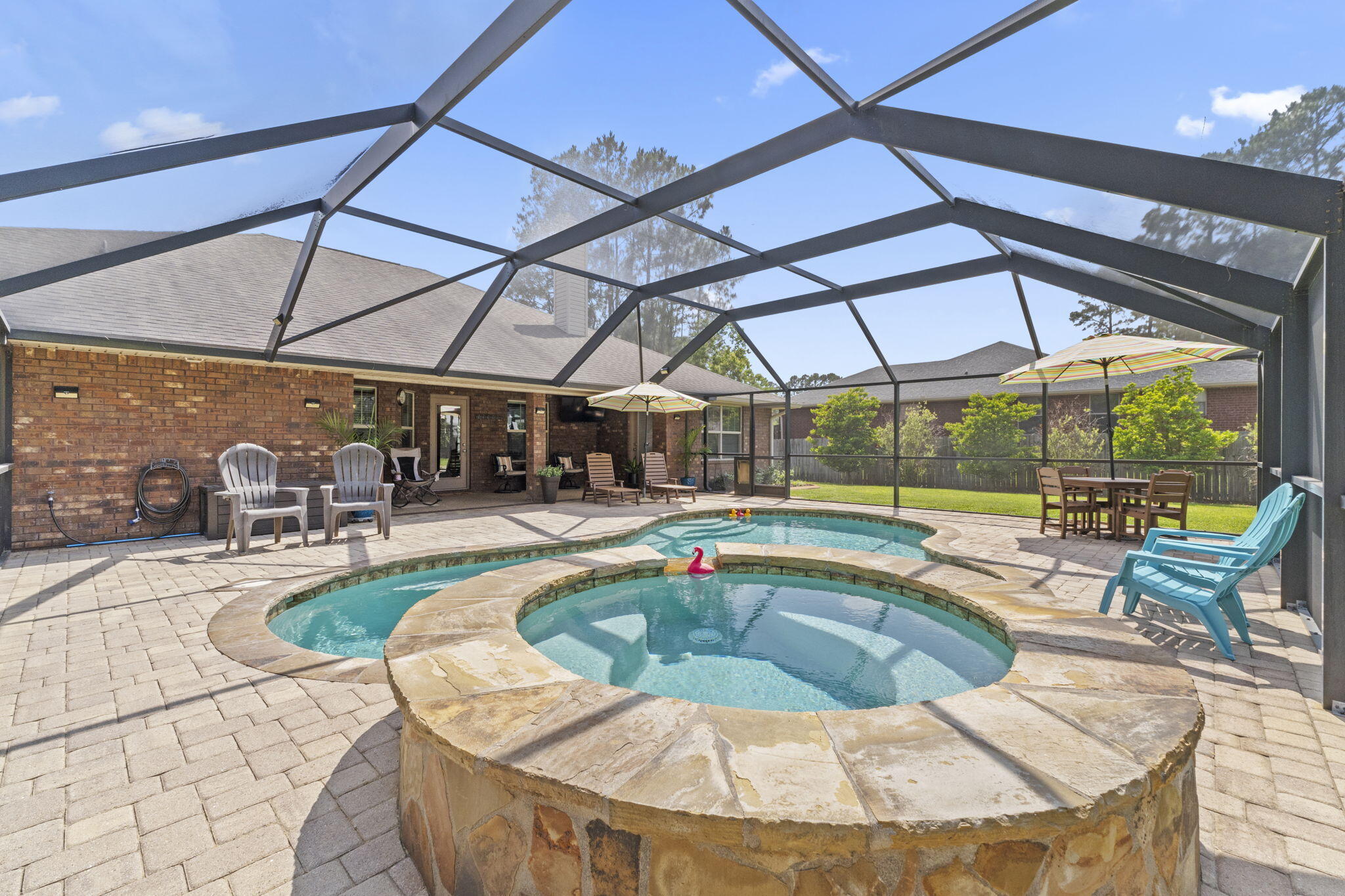 Nestled in a serene neighborhood, this exquisite four-bedroom, three-bathroom luxury home offers an unparalleled living experience. As you step inside, you'll be greeted by a grand foyer that seamlessly flows into the spacious living areas, perfect for both relaxation and entertaining. The gourmet kitchen boasts high-end stainless steel appliances, granite countertops, catering to culinary enthusiasts and social gatherings alike. Retreat to the master suite, a private oasis featuring a spa-like ensuite bathroom with a soaking tub and walk-in shower. Each additional bedroom is generously sized, providing comfort and versatility. Outside, indulge in the ultimate outdoor lifestyle with a stunning pool and hot tub, surrounded by lush landscaping that offers both privacy and tranquility.