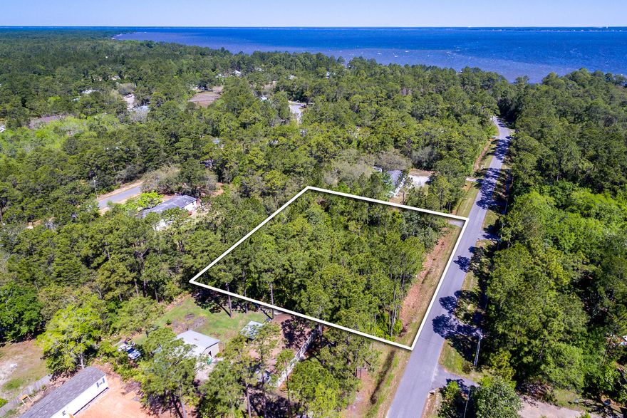 Great residential double lot 200'x180 located on a quiet paved street. The parcel is level and could be subdivided to make two separate lots. Convenient location. Close to the bay, Close to 331 and a very short drive to Destin or the beaches. Modular homes are allowed provided they meet all community requirements.