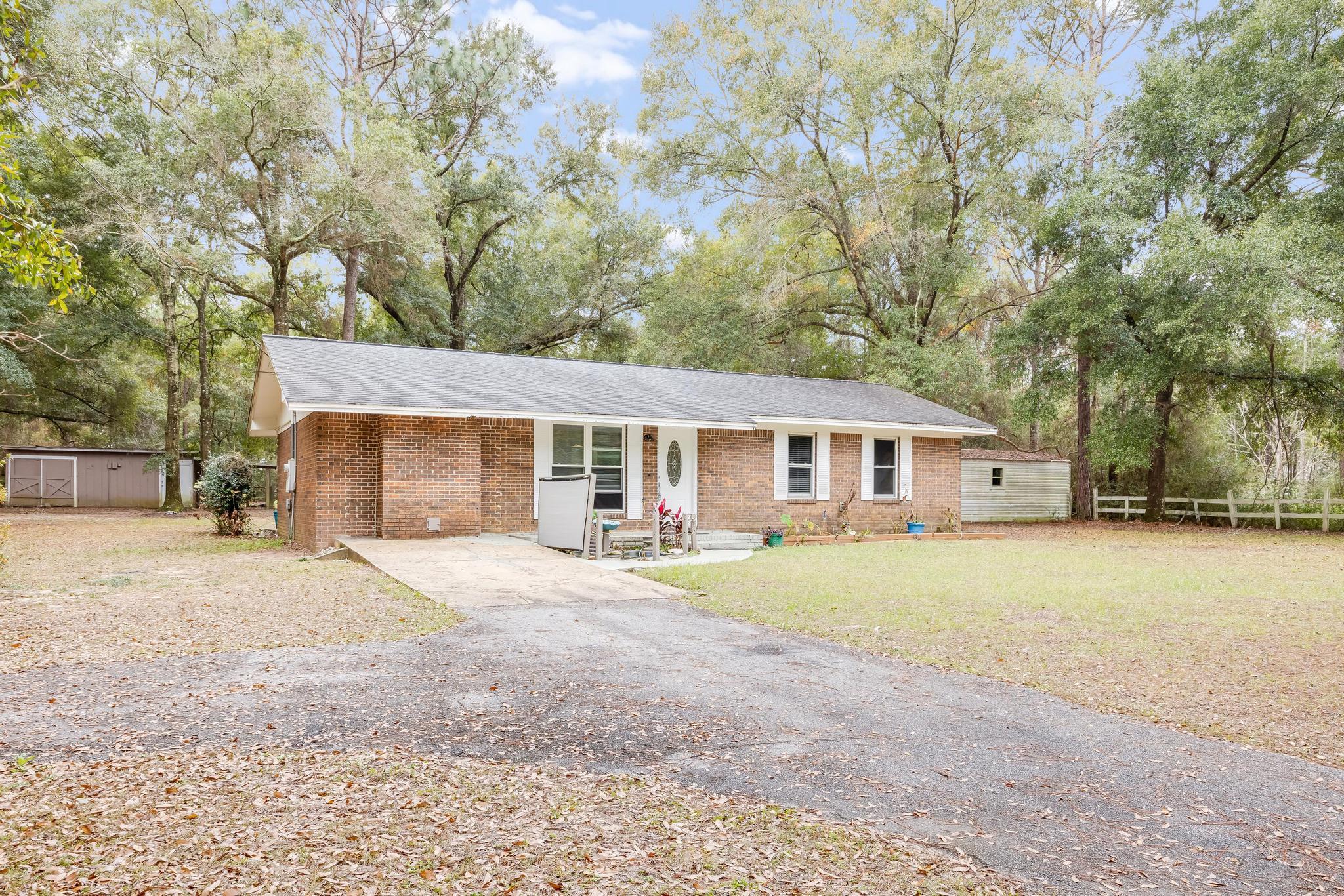 If you are looking for country living with a home that you can put your own style on, this is the one for you. This 3 bedroom home has the potential of a thriving family homestead. If you are a crafter, hobbyist, or love outdoor projects you are going to enjoy all of the potential work spaces. This is a brick home. The floor plan is open. The bedrooms are nice size. The master bath is currently a half bath but space is there to add a shower.