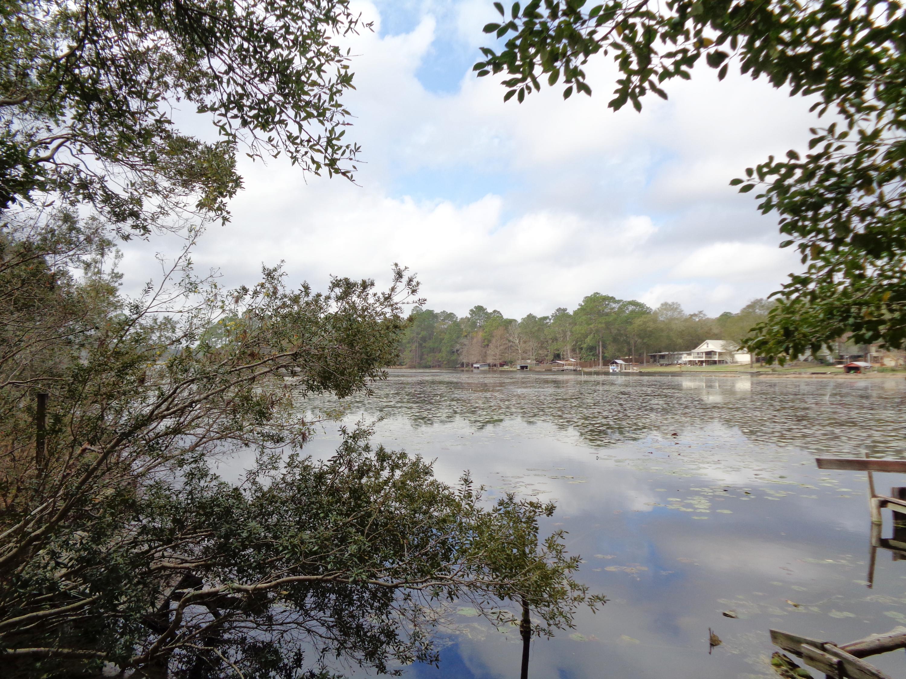 Juniper Lake waterfront lot. Previously used as a family weekend fishing camp. Old mobile home is located on the property and may can be redone. Dock and boathouse need major repairs. Great opportunity to have a waterfront lot on Juniper Lake. Being sold as is.