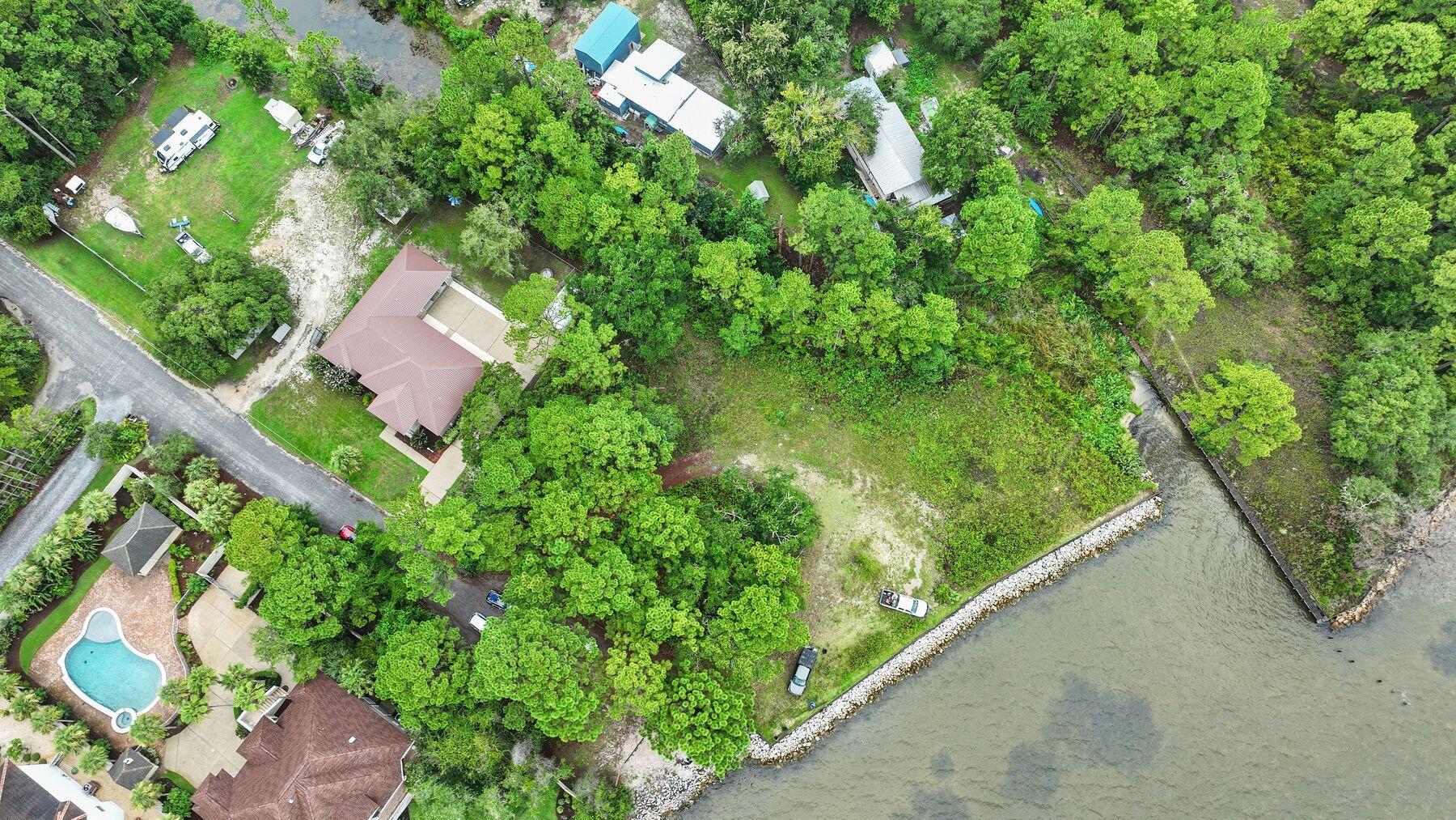 This is lot TBD 1 on the East of the lots shown.It provides a substantial build zone for an impressive single family home.An opportunity to have a dock and a great family home on the bay awaits.