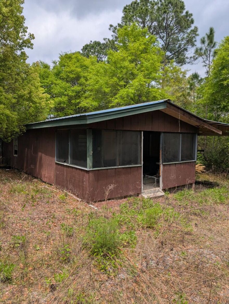 Situated on a spacious 1 acre corner lot, this property offers a unique opportunity for buyers with a vision. The home, though in need of significant renovation,  it is awaiting your personal touch. A small barn in the backyard presents possibilities for storage, a workshop, or even a hobby space. This property is ideal for those seeking a project to transform a diamond in the rough into their dream home.