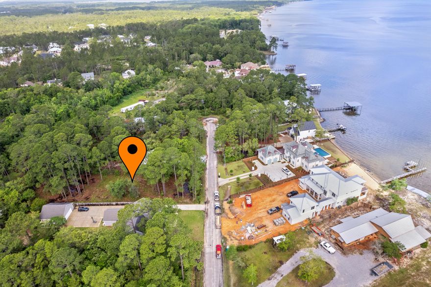 If you are looking for prime location in Santa Rosa Beach look no further! This beautiful half acre lot is located in the highly sought after gated community of Bay Pines Shores just off Chat Holley. Build your beautiful dream home and enjoy the privacy and Bay views this lot offers. The lot has been recently cleared of all brush. Small HOA fees. The HOA is discussing having the road resurfaced and also to have a boat ramp and dock for neighborhood access only. There is a survey and wetlands survey on this property (wetlands just at the front left corner of the property, the rest dry). Zoned to the highly acclaimed South Walton