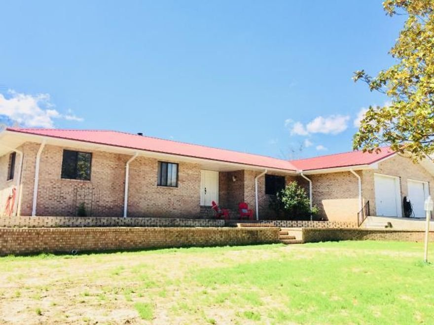 A Private and beautiful 20 acres with a large brick home is available south of I-10 and only a short distance from Defuniak Springs. Enter the property through a winding private drive to find the well-maintained home with excess of 6600 square feet under roof with over 4200 heated and cooled square feet with so many extras. There are 2 separate living areas each with a fireplace and kitchen. The main floor has 4 bedrooms, 2 -1/2 baths, and extra-large living, dining, kitchen and laundry rooms. Downstairs you will find a large living area, kitchen, bedroom and bathroom. Also included is a 15' x 23' deck and a 15' x 23' covered porch and a 24'x20' out building. Come see if this homestead is ideal for your family. Buyer to verify measurements & information.