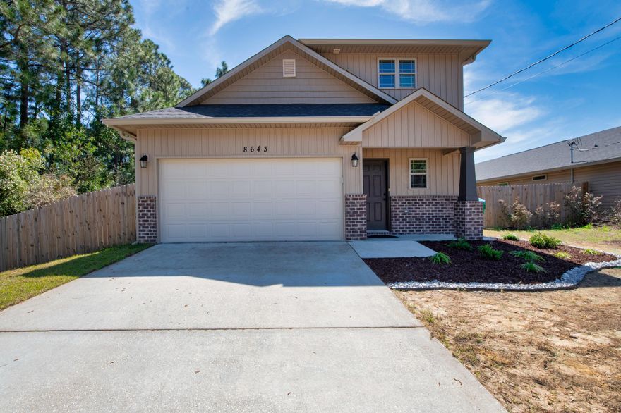 There is no better place in Navarre to live, than 5 minutes from the bridge. Featuring 3 bedrooms, 3 bathrooms, over a third of an acre of flat land, comes to the marketplace 8643 Laredo St! Built in 2017, you can rest assured maintenance items are decades away from replacement. Beautiful earth tones on the exterior and interior yield a modern, yet refined appearance. Woodlook LVP floors throughout create a clean and cared for vibe, as they lead you right into the open concept vaulted ceiling living space. The living room ceiling is over 20' tall, overlooked by your gourmet chef's kitchen. Granite counters, stainless appliances, craftsman cabinetry all combine for the perfect balance of modernity. The upstairs loft is a wonderful place to relax. The fenced large yard is a haven for pets! Book your private showing today for an opportunity to own this prime location property in Navarre. 