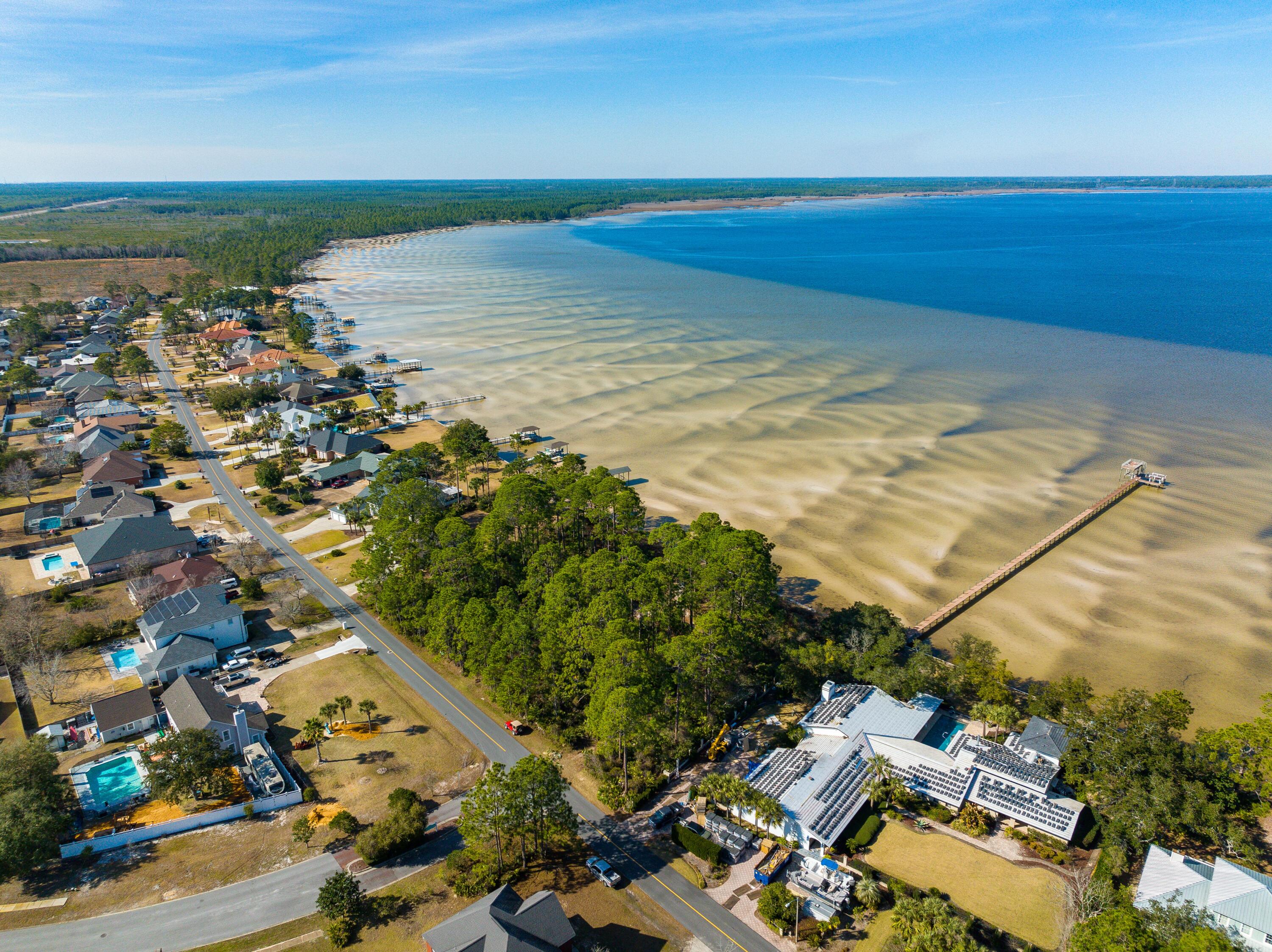 Awesome LOT with 103 BAY-FRONT FT and GULF ACCESS! Looking for a slice of untouched paradise in one of the fastest growing areas of FL! This VERY RARE gem can be your blank canvas to write your own story. Drive just a few miles away from LUXURIOUS Scenic Highway 30-A & the shops & restaurants of Pier Park to find yourself in what feels like another world. Here, time slows down. You've discovered the slow-moving saltwater marsh known as West Bay, one of the most beautiful secrets of the Emerald Coast. 25 minutes by boat to the turquoise waters of the beach, you truly can experience the BEST of both worlds! This fortified parcel is protected by a Sea Wall to prevent erosion.