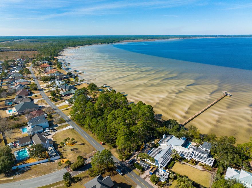 Awesome LOT with 103 BAY-FRONT FT and GULF ACCESS! Looking for a slice of untouched paradise in one of the fastest growing areas of FL! This VERY RARE gem can be your blank canvas to write your own story. Drive just a few miles away from LUXURIOUS Scenic Highway 30-A & the shops & restaurants of Pier Park to find yourself in what feels like another world. Here, time slows down. You've discovered the slow-moving saltwater marsh known as West Bay, one of the most beautiful secrets of the Emerald Coast. 25 minutes by boat to the turquoise waters of the beach, you truly can experience the BEST of both worlds! This fortified parcel is protected by a Sea Wall to prevent erosion.