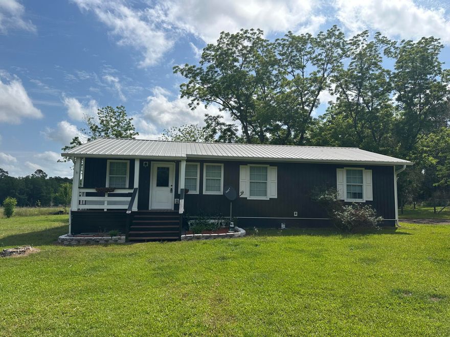 Offering $5,000 buyer's concession! This charming farm house sits on three acres of prime country land that include pecan trees, mature pines, fenced in back yard, private well,  and plenty of room for gardens and animals. 2018 metal roof & hot water tank! Updated kitchen with quartz countertops, newer cabinets, and appliances. Washer and dryer stay with property. Both bathrooms were recently updated as well. Spacious front and back porch perfect for relaxing evenings. Storage shed will stay with sale of property. Contact us to schedule your showing before it's gone!