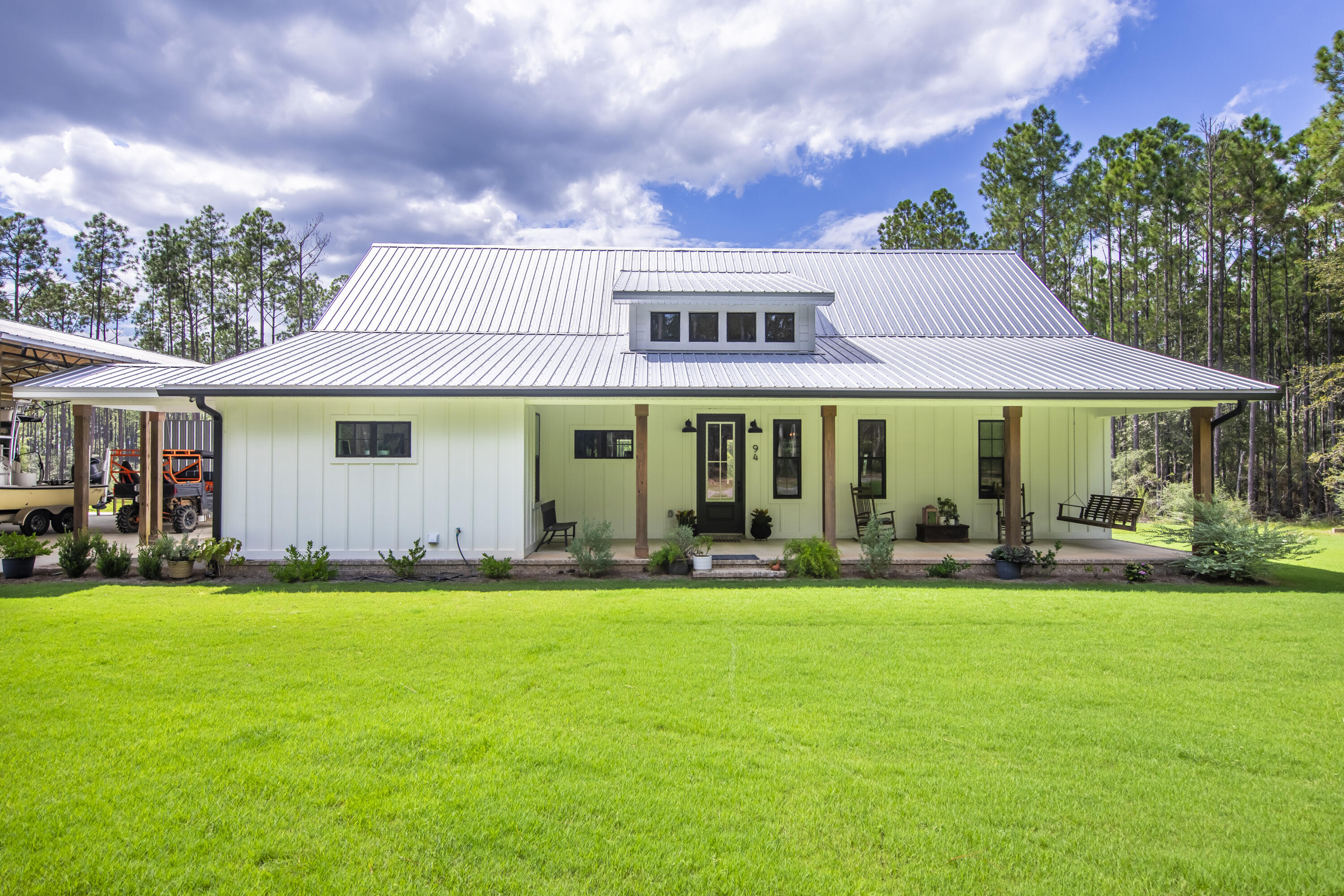 Eight acres of privacy only 6 miles North of Freeport or South of Defuniak. No need to pay for storage, park the toys under the pole barn on property. This 2,022 sqft home built in 2022 offers large open living area with split bedrooms. Beautiful covered front porch and large entertaining porch at the rear. Features include solid wood cabinetry, quartz countertops and engineered hardwood flooring with tile in the wet areas. Gas fireplace, cook top and tankless hot water heater. Crown molding, 8' solid doors and cased windows throughout. Irrigation system, window treatments, gutters and landscaped. Pole barn, 2 storage sheds and 5 dog kennel included.