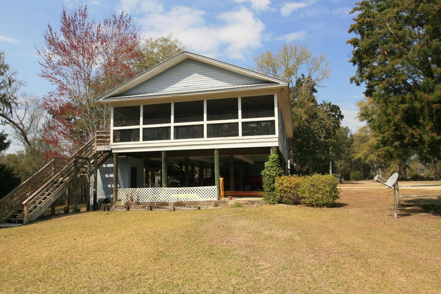 DEEPWATER home on Black Creek with dock and adjacent to Happy Hollow neighborhood boat ramp! If you enjoy privacy, boating, sailing, kayaking, and a beautiful view, you need not look any further. Located on a large lot at the end of Creekview Ave, you have total privacy on the south side due to a wooded buffer area. Raised on stilts, the one owner home was built to remain high and dry. Meticulously maintained, the interior of the home is welcoming and has views from every room. The heart of the home is a large kitchen and great room with fireplace. Double doors open from the great room onto the well-built deck which is covered and screened in. The deck is the entire width of the home and allows you to enjoy all the weather changes, peace and beauty of your waterfront home. see more