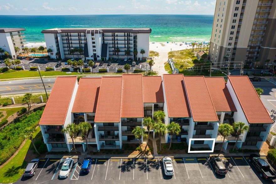 This first-floor condo is the perfect base for enjoying the warm gulf waters and glimmering white sands at Panama City Beach. Superbly located, this gulf-view apartment has updated kitchens and bathrooms with shiplap accents reinforcing the beachy vibe. Tile floors flow throughout the Condo from the charming entrance hallway and living room to the covered porch. Mirrored walls introduce additional light to the living area, which has ample space for a comfy sitting area and dining table. Updated counters in the kitchen extend to create a generous breakfast bar/casual eating area. The kitchen has recently had a facelift with all-new stainless steel appliances and updated cabinets giving it a fresh modern look. Louvered doors hide a fully equipped laundry space. An open doorway leads to two bedrooms separated by a family bathroom. The light-filled master bedroom has sliding doors providing direct access to the terrace for morning coffee before the day begins. The ensuite master shower room has been recently updated with a beautiful white double vanity and a fully tiled walk-in shower. The guest bedroom has ample space for two queen-sized beds and also has full-height glass doors leading out to a paved patio overlooking the car park. Just a two-minute walk or tram ride to the private beach, this condo has excellent onsite amenities including golf, tennis and basketball courts, several pools with lounge chairs, hot tubs and gated security. WonderWorks, a trampoline park and Shipwreck Island are nearby along with shops, supermarkets and restaurants lining Highway 98  all this at a most attractive price point. 