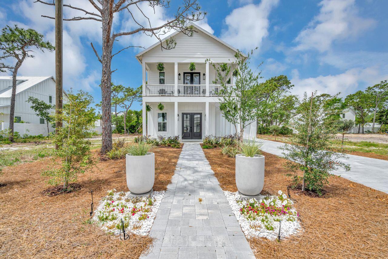 Price reduced! Beautiful new construction home, and stunning new coastal furniture, entirely furnished! This includes new washer and dryer as well. Beautiful bedding and bathroom linens included. Less than four blocks from the beach! Five bedrooms all come with a private bathroom and an extra one-half bath on the main level. Open floor plan living area and kitchen on the main floor with ten-foot ceilings. The living area opens to a covered porch to enjoy the outdoors. Primary suite on the main level for convenience. Also, a mud room with a door to the outside for beach traffic. Fully equipped kitchen with gas stove. Upstairs you will find four additional bedrooms plus an office/bunk room all with ten-foot ceilings. French doors lead to wrap wrap-around balcony to enjoy the gulf breezes. Oversized garage perfect for extra storage for paddle boards and water toys or even a golf cart. New, freshly landscaped that adds a special touch.