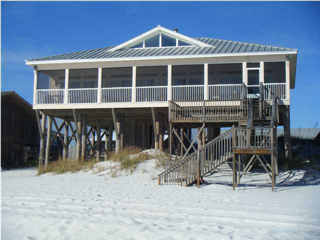 Gulf front-Gulf front-Gulf front. This Gulf front beach home across from Oyster Lake in quiet Dune Allen has an open plan designed to maximize views of the Gulf of Mexico. The living/great room, dining room, game room and even kitchen have panoramic views of the Gulf through sliding glass doors stretching the entire south side of the home. Situated gulf front and in the middle of the home is the living/great room, with a custom coral fireplace and 16 ft. pecky cypress beam/mantel and matching bookshelves. The whitewashed wood, vaulted ceilings and sliding glass doors fit harmoniously with the beach landscape. A wet bar in the game room and 2 coral-top sofa tables also reflect and enhance this natural beach theme.