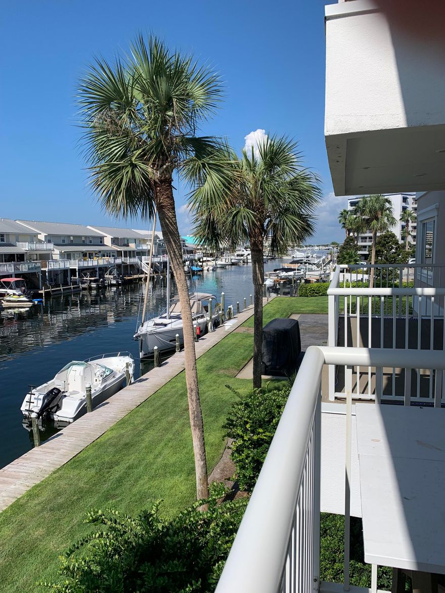This beautifully renovated 2-bedroom, 2-bath condo on the 2nd floor of Sun King Towers in Destin offers stunning canal views and Gulf access from a private, gated community on Holiday Isle. Features include a chef's kitchen with quartz countertops, new appliances, and in-unit washer/dryer. Relax on two covered balconies or by the secluded pool and 2-story pool house with kitchen and waterfront meeting room. Boat slips are available on a first-come-first-serve basis for rent at $500/year, including water and power. Just a 10-minute walk to Destin's white sandy beaches, this condo is a rare coastal retreat with hurricane impact windows and doors for peace of mind.