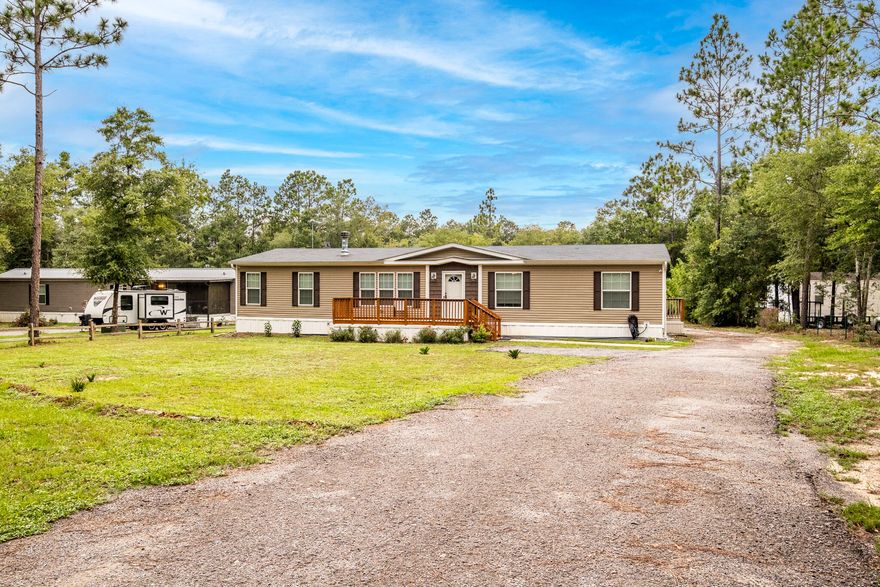 Move in Ready! Find your privacy at this 4 bedroom, 2 bathroom double wide home with a screened in porch that sits on a spacious .84 acre lot. Each bathroom features a garden tub for relaxation. This summer, cool off in the 20' above ground pool and when winter arrives, cozy up next to the fireplace. In addition to the main residence, this property features a detached 3-car garage with 120 & 240 electrical, RV hook up, Generator hook up, automatic doors and workshop.