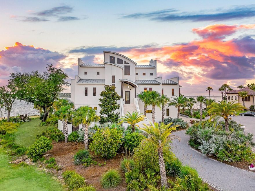 Discover unparalleled luxury on a private island in northwest Florida, where contemporary architecture meets serene tropical beauty. This extraordinary masterpiece was recently featured on HGTV House Hunters Amazing Water Homes in January 2025 and is even more stunning in person than on international TV! As you approach Northshore Islands, you're greeted by only a few homes and this home exudes privacy, exclusivity and remarkable architecture. Built by Rita Jones with the design team of Architect Michael Hunnicutt, and Katie Fisher Design, Interior Design, this exceptional three-story contemporary, modern estate spans over 5,000 square feet, offered fully furnished with NEW furnishings and offers breathtaking waterfront views from every room. Enjoy expansive outdoor living with bay-view covered porches on each level, perfect for soaking in the tranquility of the surroundings on the island. 

Imagine leaving your dock for Shell Island or heading out for a sunset cruise. Picture yourself with the kids by the pool while watching the sun sink into the horizon. This is one of the very few locations in Panama City, Florida that has been built based on the picturesque views and was designed to maximize views of the water from all angles. This private island is a truly a waterfront dream come true! 

For boating and fishing enthusiasts, the property features a private, recently renovated, 350' dock with deep water access to the Gulf of Mexico, which is just 10 nautical miles away with no idle speeds zone in between, offering endless opportunities for fishing and adventure. The dock also holds a 2021 Barletta Pontoon boat on lift and a NEW 40,000 LB boat lift, ALL of which will convey to the new owner to be able to enjoy the waterfront lifestyle from day one! Not looking for boating adventure? This home offers zero entry into the Bay which is perfect for kayaks, paddleboards and swimming as you watch the picturesque sunset set in the West each day. The island's natural landscaping and soothing bay sounds welcome you to this peaceful retreat, where indoor and outdoor spaces blend seamlessly with a saltwater pool and spa. 

Upon approach to the circular cobblestone paver driveway, you're greeted by sea breezes and a travertine marble tile entry and a foyer framed with a custom Mahogany wood door with artistic blown glass. Entering the main level, the stunning waterfront views stand out as you sit at 23' elevation and enjoy a great room that offers views of the island from all angles. The family room area is framed by custom millwork and a modern linear fireplace surrounded with marble and slate tile creates warmth in the space while framing a wall of full-glass French doors that lead out onto a covered patio overlooking both pool and Bay. From here you can take in gorgeous year-round sunsets as they sink into the horizon each evening. This level also features a light-filled dining room overlooking the natural landscape of the island and a powder room with Onyx walls and custom pedestal sink for guests, and a junior suite overlooking Bay and pool complete with full bath, walk in closet, and Juliet balcony. Luxurious polished travertine tile is consistent throughout the main floor in the great room for a seamless look. 

The open kitchen is fully-equipped and features a custom slab walnut cabinetry, 48'' Thermador Professional convection microwave oven, warming drawer, Viking range hood and full-size Electrolux refrigerator and freezer. A Caesarstone Quartz waterfall countertop island is a showpiece and the oversized island seats 4. The bar and new wine refrigerator are excellent for entertaining and just off the kitchen and adjacent to the 16'x10' walk-in pantry and laundry room with stunning granite countertops, custom cabinetry, washer and dryer and the most perfect views of the island!

The primary suite, just off the kitchen, is a haven of luxury, offering radiant heated Italian porcelain tile floors, a spa-like Grohe walk-in shower with 3 body jets and 2 hand showers, new freestanding tub overlooking the Bay, slab walnut cabinetry with Swarovski crystal knobs and direct access to a waterfront patio with a fireplace. This retreat also features a large 14'x9' closet in the primary suite featuring fully enclosed cabinetry.

The lower level outdoor summer kitchen is an entertainer's dream, overlooking the Bay and pool, is equipped with new luxury appliances, Caesarstone quartz countertops, and custom walnut cabinetry. The pool is framed with luxurious custom tile, Travertine decking and offers new equipment for easy maintenance. With an 18' deep covered patio, your entertaining dreams will become a reality in this world-class outdoor living area. Overlooking the Bay, your boat and the best sunsets that Panama City has to offer - you can't wait to call this one home.

The third level provides a 19"x16" loft living area with remarkable barreled tongue and groove ceiling, waterfront office filled with floor to ceiling glass and doors, and two en suite guest bedrooms, each with walk-in closets and recently renovated luxurious private en suite bathrooms with marble and custom tile finishes.

The lower level includes a 35"x24" 4-car tandem garage, 15"x10" workshop space, media-game room with full kitchenette, full bathroom and a walk-in wine room, ideal for entertaining being just off the outdoor summer kitchen and pool area.

The home's robust construction features cement-filled concrete block walls, hurricane-rated Anderson windows, 150-mph wind rated garage doors, safe room and a 1/2" tempered, frameless glass railing system for unobstructed Bay views. A built-in generator fully powers the second and third floors of the home and there are high-efficiency heat pumps for each floor providing comfort and convenience. A solid, standing seam aluminum roof was installed in 2019. The home has a 500-gallon underground propane tank and infrastructure on the island includes high speed internet, city water and sewer.

This exclusive waterfront home offers a rare opportunity to live the coastal life you've always desired.