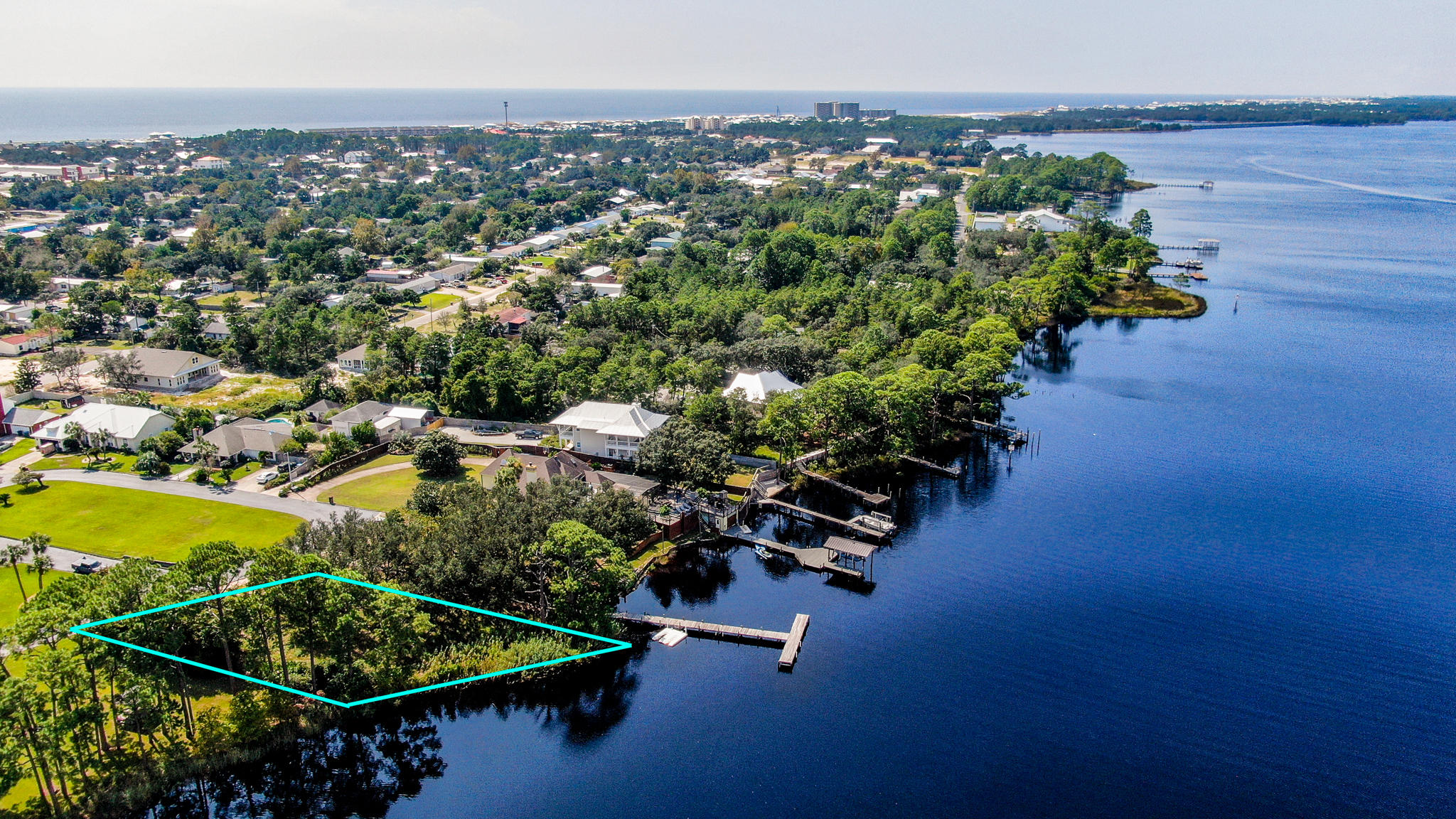 Absolutely stunning waterfront lot on Lake Powell perfect for building your dream homes. Located in Palmetto Bluff a small gated community with a community dock and tennis courts. Possibilities are limitless for this beautiful home-site. Lake Powell is the largest Dune Lake in the state of Florida and holds an award of 'Pristine Florida Waterway'. Enjoy your days fishing, paddle boarding or jet skiing right from your backyard. You may choose to kayak or boat over to the beach to watch the sunset over the Gulf. Bring your offer today! All measurements and information are to be verified by buyer.