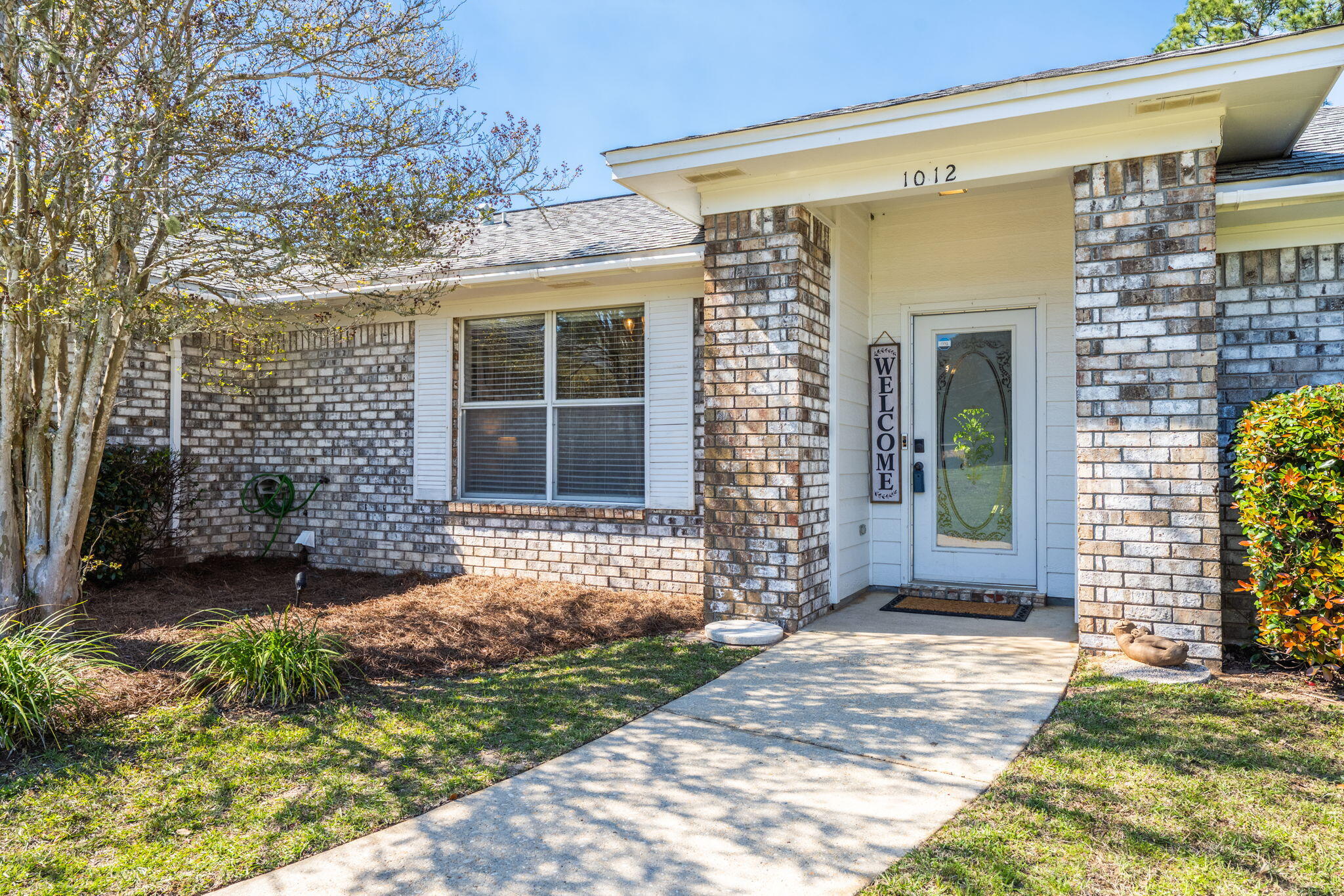 Situated at the end of a peaceful cul-de-sac in a well-kept neighborhood, this lovely three-bedroom, two-bathroom brick home offers both comfort and functionality. The inviting interior features luxury vinyl plank flooring throughout, with plush carpet in the bedrooms and living room. The spacious living room is highlighted by a cathedral ceiling and a cozy fireplace, creating a warm and welcoming atmosphere. An adjoining family room provides the perfect flex space for a home office, formal dining area, or additional living space to suit your needs. The bright and airy kitchen boasts a skylight that floods the space with natural light, an island with a breakfast bar, and ample cabinet space along with a pantry for extra storage. There is also a dedicated dining area with plenty of room f or a table, making mealtime gatherings a breeze. The split floor plan ensures privacy, with the spacious primary bedroom tucked away on one side of the home. Its ensuite bathroom is complete with double sinks, two walk-in closets, and a relaxing garden tub/shower combo beneath another skylight. Conveniently located nearby, the generous laundry room adds to the home's practical layout. Two additional bedrooms and a full bathroom are situated on the opposite side of the home, providing a comfortable retreat for family or guests. Outside, the backyard features mature trees and an open patio, perfect for relaxing or entertaining. A two-car garage adds to the home's convenience and storage options. This lovely West Pensacola home offers a wonderful blend of space, style, and versatility in a desirable location. Don't miss your chance to make it your own!