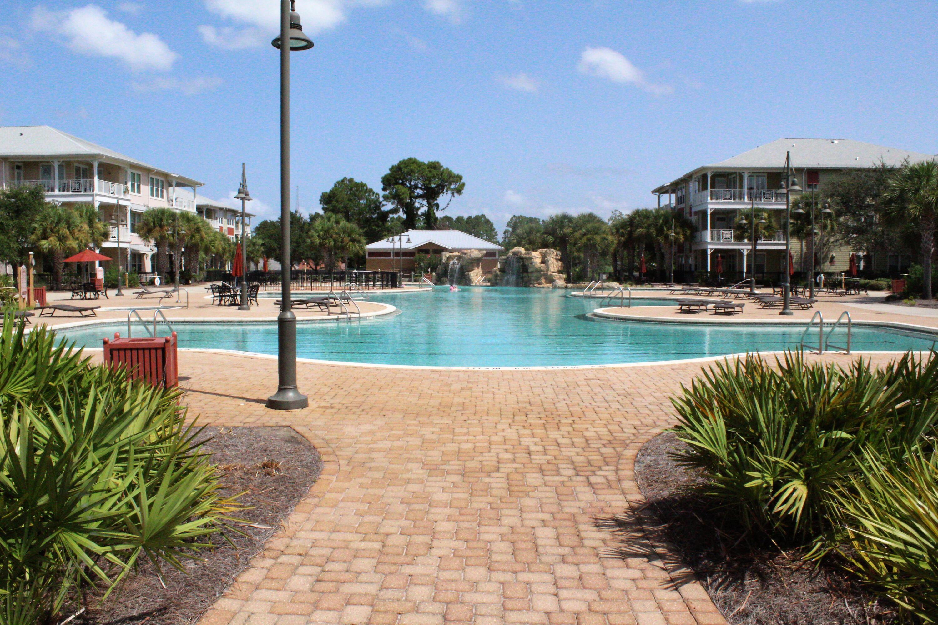 In summary, this 2-bedroom, 2.5 bath condo offers a unique opportunity to embrace the beach resort lifestyle. From the beautifully designed interior to the exceptional pool area and abundant amenities, this condo is a true gem for those seeking a coastal paradise. Upon entering this spacious condo, you are greeted by an open-concept family room, breakfast room and kitchen. The family room boasts large doors that flood the space with natural light. The kitchen is a chef's delight including granite countertops, and ample cabinet space. It's perfect for preparing meals for family and friends. The breakfast bar provides additional seating and creates a seamless transition between the kitchen and the breakfast room and family room area. The master bedroom is a sanctuary of relaxation. It features a spacious layout, a private en-suite bath. The second bedroom is equally inviting, ideal for guests or family members. Both bedrooms have private doors with direct access to the balcony. Step outside onto your private balcony, where you can savor your morning coffee or evening cocktails. Imagine lounging by the crystal-clear pool, surrounded by palm trees and comfortable sunbeds. The pool area with rock waterfall, splash pad and hot tub is meticulously maintained and offers a tranquil escape from the daily grind. It's perfect for sunbathing, swimming laps, or simply floating your cares away. Indoor pickle ball court/basket ball court is great for the work out enthusiast. Full gym also available to keep in shape. Game room and theatre room for family entertaining venue. Island Reserve sure is resort living at it's finest and only 1.4 miles to the beautiful gulf and sandy white beaches. Come and See