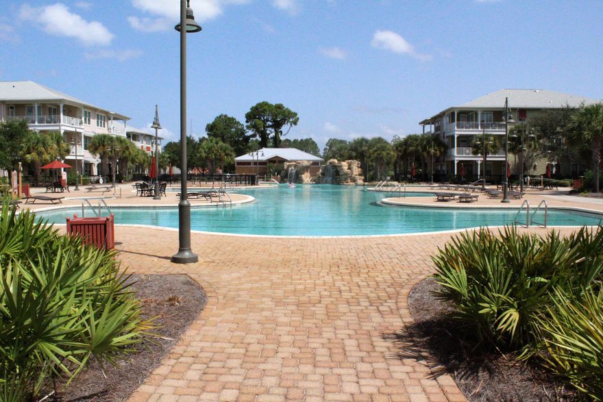 In summary, this 2-bedroom, 2.5 bath condo offers a unique opportunity to embrace the beach resort lifestyle. From the beautifully designed interior to the exceptional pool area and abundant amenities, this condo is a true gem for those seeking a coastal paradise. Upon entering this spacious condo, you are greeted by an open-concept family room, breakfast room and kitchen. The family room boasts large doors that flood the space with natural light. The kitchen is a chef's delight including granite countertops, and ample cabinet space. It's perfect for preparing meals for family and friends. The breakfast bar provides additional seating and creates a seamless transition between the kitchen and the breakfast room and family room area. The master bedroom is a sanctuary of relaxation.  It features a spacious layout, a private en-suite bath. The second bedroom is equally inviting, ideal for guests or family members. Both bedrooms have private doors with direct access to the balcony. Step outside onto your private balcony, where you can savor your morning coffee or evening cocktails. Imagine lounging by the crystal-clear pool, surrounded by palm trees and comfortable sunbeds. The pool area with rock waterfall, splash pad and hot tub is meticulously maintained and offers a tranquil escape from the daily grind. It's perfect for sunbathing, swimming laps, or simply floating your cares away. Indoor pickle ball court/basket ball court is great for the work out enthusiast. Full gym also available to keep in shape. Game room and theatre room for family entertaining venue. Island Reserve sure is resort living at it's finest and only 1.4 miles to the beautiful gulf and sandy white beaches. Come and See