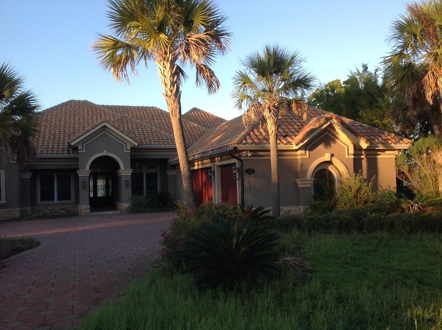 This GORGEOUS stucco home has it all! Beautiful bay front view, in ground pool, hot tub, built in grill, wet bar, wine cellar, wine refrigerator and more. Spacious foyer with tile floors and beautiful columns as well as a fireplace. Mahogany front doors with leaded glass, split floor plan, formal dining room, cathedral ceiling, separate study with custom built in shelves and cabinets!