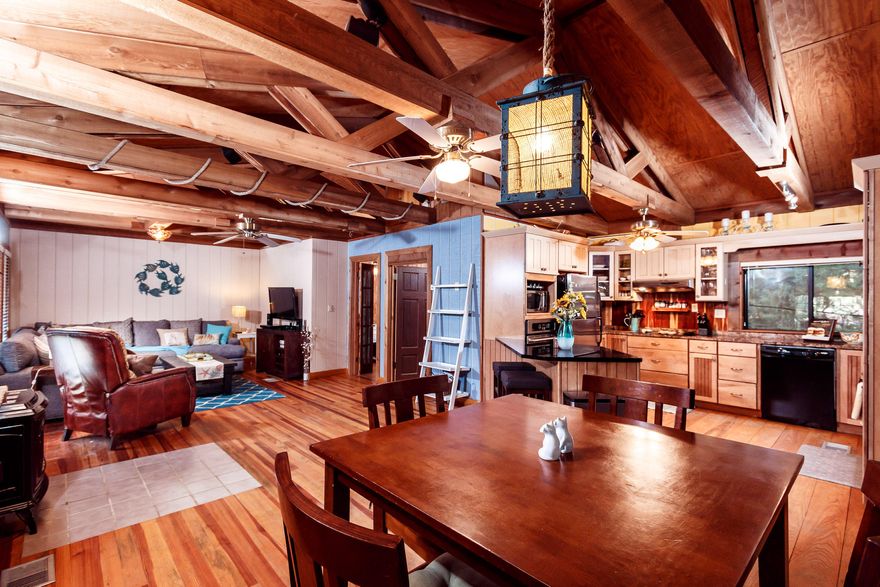 Looking for character? How about southern charm? This home has it and just 5 minutes into Niceville. With a split floor design, this rustic cottage maintains a spacious living area, kitchen, and spare bedroom on the top floor. The kitchen is equipped with granite counter tops, stainless steel appliances, and an open concept into the family room. Take a load off underneath beautiful wooden beams lining the ceiling or sit outside on your wrap around covered porch. Downstairs you will find a quaint sitting area, indoor laundry room, large master bedroom, and an office over looking the fenced-in back yard. The yard has plenty of storage with TWO storage sheds, one which has been converted into a home gym.This home sits within a block of the Bay! Walk out and see these beautiful Florida sunset.