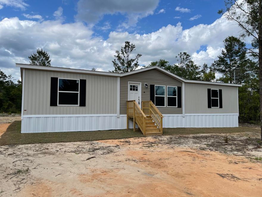 MOVE IN READY 3 Bedroom 2 Bath Manufactured Home. This home is ENERGY STAR RATED with upgraded insulation, OSB Wrap with House Wrap, Lux Low E Thermo-Pane Windows that fold down for easy cleaning. This home has a framed decor accent wall in the living area & wall to wall vinyl plank flooring. Kitchen is equipped with deep stainless steel kitchen sink, fully cabinet/wall encased refrigerator, Kitchen Island and a fantastic coffee bar set-up between the kitchen and laundry room. The master bathroom features a double vanity and 40'X60' soaker tub/shower combo, with 1 walk in closet in the bathroom and another walk-in closet in master bedroom. Guest bedrooms both have decent sized closets. Home will have a 5 year homebuyer protection plan in place at the time of a successful closing!