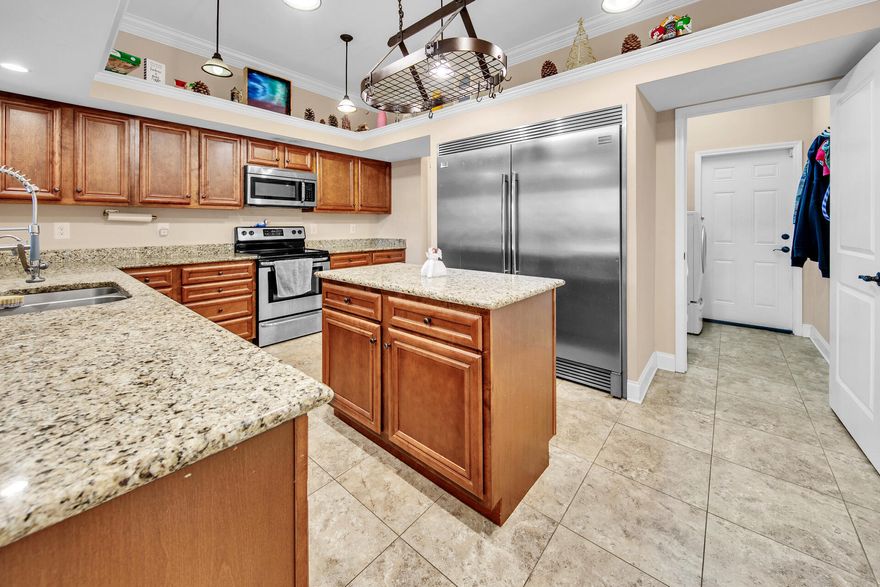 Welcome to your dream home! Crafted with excellence in 2012 by a locally renowned builder, this stunning abode boasts quality craftsmanship and exquisite details. Step inside to discover an inviting open concept layout, featuring four generously sized bedrooms and two bathrooms. Upon entry, you're greeted by a versatile space ideal for formal dining or a cozy sitting area, setting the tone for elegance and comfort.Prepare to be dazzled by the chef's kitchen, meticulously designed to cater to culinary enthusiasts.  Features maple wood cabinetry, top-of-the-line stainless steel appliances, including a commercial-grade built-in refrigerator/freezer, and a spacious bar complemented by a separate island, this kitchen is truly remarkable.