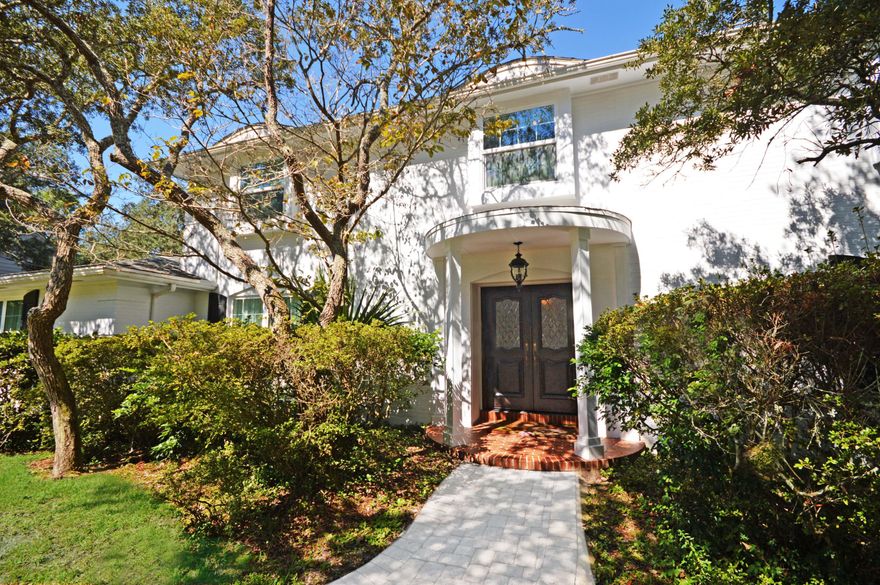 GOLD STAR PROPERTY HOME WARRANTY!An enchanting home awaits in Lake Lorraine! It is not often a pristine, custom home in a desirable neighborhood becomes available. Enter through the custom front doors into an exquisite Italian marble tiled foyer. This home boasts 2 fireplaces in each living area. The front room displays a one of a kind electric fireplace while the more casual living room offers a gas fireplace and a wall of windows overlooking the pool and golf course. BEAUTIFUL and new Bruce hardwood floors in dining and living areas. Large kitchen with custom built cabinets, quartz kitchen counter tops and a double oven perfect for the chef! All new impact glass windows and doors. All bathrooms remodeled with granite. Master bedroom has beautiful sitting area with built in cedar cabinet.