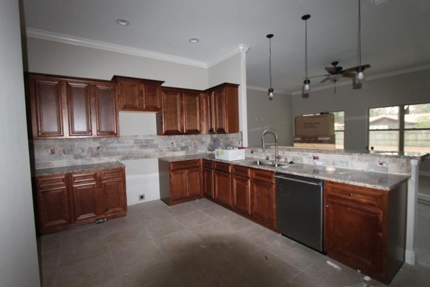 Awesome new floor plan, offered by a multiple award winning builder and a 2017 Parade of Homes winner! Home is on a huge lot (100x150), with beautiful mature trees which is also in a quiet neighborhood with location, location, location. Seller is offering to pay $4500 in buyer closing costs and title, as well as supply 2'' faux wood white blinds, with a full price offer and the use of a preferred lender. This 4/3 custom brick plan has super curb appeal. There are 10 ft. ceilings w/ impressive crown molding. There is Bamboo hardwood flooring and and 5 1/4'' baseboard throughout the main living areas. Tile is in wet areas.