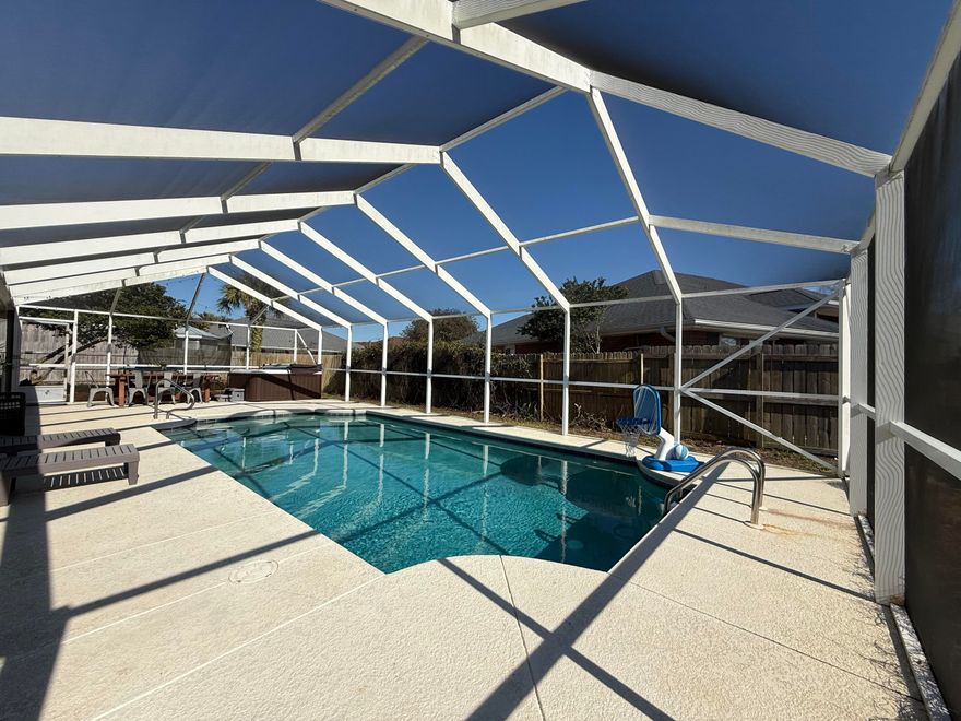 East Navarre Pool home with Prime Location! Professional pool maintenance is included!! Welcome to this inviting 4-bedroom, 2-bath residence ideally situated near the beach and Hurlburt Field. The home boasts a tastefully updated kitchen featuring granite countertops and stainless steel appliances, perfect for everyday living and entertaining. Positioned on a desirable corner lot, the property offers an expanded side-entry driveway with ample space for boat or RV parking. Step into the spacious, private backyard where you'll find an enclosed saltwater pool and hot tub, your own personal retreat. Additional highlights include renovated bathrooms, a generously sized laundry room, and a detached outdoor workshop for extra storage or hobbies.