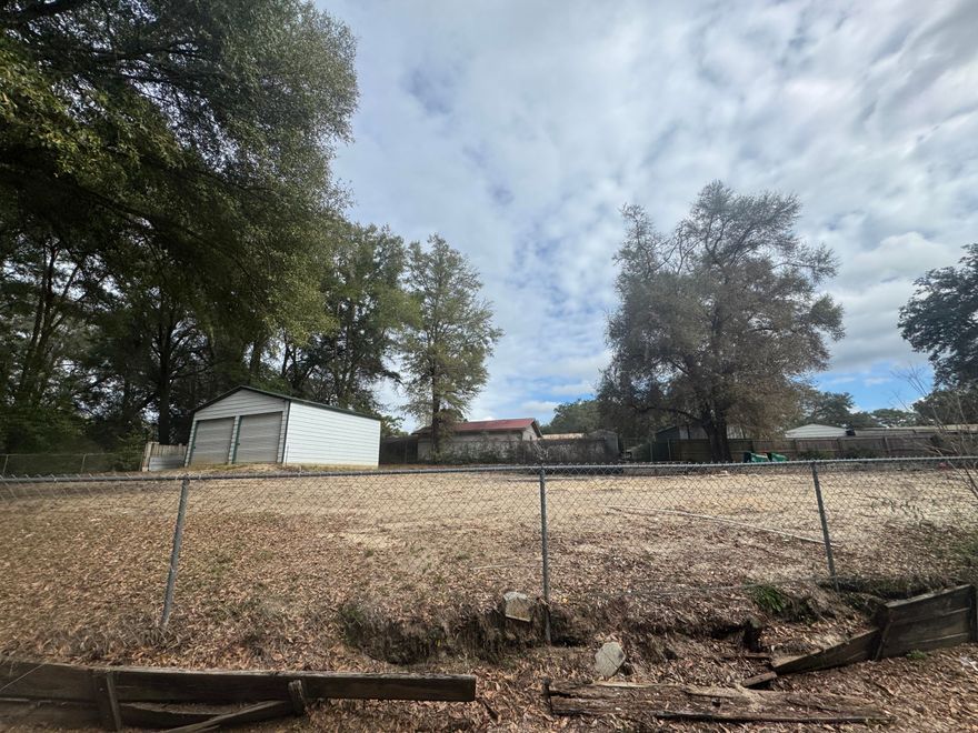 Opportunities like this don't come along often. Located in the center of Crestview, this .30-acre vacant lot is cleared, fully fenced, and ready for your next move--whether that's building a new home, placing a mobile home, or launching a home-based business.The property previously housed a mobile home, which has been removed, leaving behind valuable infrastructure already in place. Utilities are available, the water tap fee has been paid, and a septic tank is on the property, saving you significant time and expense.A standout feature is the 24x25 steel building on a concrete foundation, complete with two large roll-up doors and a standard walk-through door--ideal for a workshop, storage, or small business operation.Mature trees provide shade and character, while the central location puts you just minutes from Publix, Bob Sikes Airport, and Downtown Crestview. Just 30 minutes to Eglin AFB.

If you're looking for flexibility, functionality, and a location that truly delivers convenience, this property checks every box. Bring your plans and make it yours.