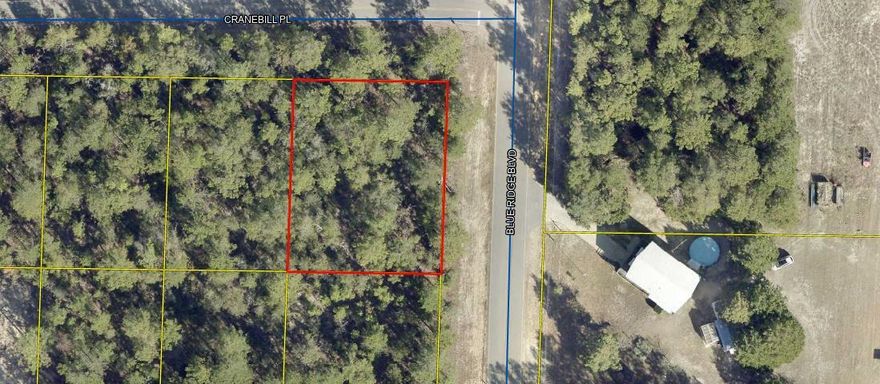 Wooded lot located on the corner of paved roads. Perfect place to build your dream home or place a manufactured home.