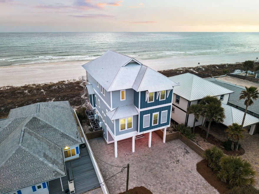Perched on 50 feet of pristine Gulf frontage, 16525 Front Beach Road offers a rare opportunity to own a Gulf front home in Panama City Beach with sweeping views of the Gulf of Mexico, private beach access, and exceptional rental potential. This beachfront property combines the privacy of a luxury coastal retreat with the income potential investors seek along the Emerald Coast.Built on a solid concrete piling foundation and maintained in like-new condition, this beach front home has never been rented and is offered fully furnished, making it a true turnkey opportunity. With rental projections of $359,424 annually and accommodations for up to 22 guests, the property presents a compelling investment for buyers seeking a high-performing Panama City Beach vacation rental or a legacy Gulf Front family retreat. Designed to maximize the Gulf views, the home features three expansive balconies connected by a spiral staircase, creating multiple outdoor living spaces with panoramic water views. Two Gulf-facing bedrooms open directly to private balconies, allowing you to wake up to the sound of waves and uninterrupted views of the Gulf. The second floor serves as the main living level with an open concept kitchen, dining, and living area that flows seamlessly to a large balcony overlooking the beach. The kitchen is thoughtfully designed with quartz countertops, custom cabinetry, tile backsplash, a large island with seating for six, gas range, built-in ice maker, and double sinks, making it ideal for entertaining large groups. The first floor is designed for gathering and recreation, featuring a bunk room and recreation room that opens directly to the private heated pool area. A built-in bar with ice maker and beverage refrigerator creates the perfect space for poolside entertaining after a day on the beach. Throughout the home you'll find shiplap accent walls, ensuite bathrooms in every bedroom, generous owner storage closets on each floor, and integrated WiFi extenders with indoor and outdoor speakers. The primary suite offers Gulf views, a private balcony, walk-in closet, double vanity, garden tub, and separate shower. Outside, enjoy the convenience of a private beach walkover, outdoor shower, Polywood outdoor furniture, and abundant parking rarely found in Gulf front homes. The location offers a quiet stretch of beach with no nearby public beach walkovers while still being just minutes from Pier Park's restaurants, shopping, and entertainment. 16525 Front Beach Road is a rare Panama City Beach Gulf front home offering privacy, durability, luxury amenities, and strong vacation rental income potential all in one exceptional beachfront property.