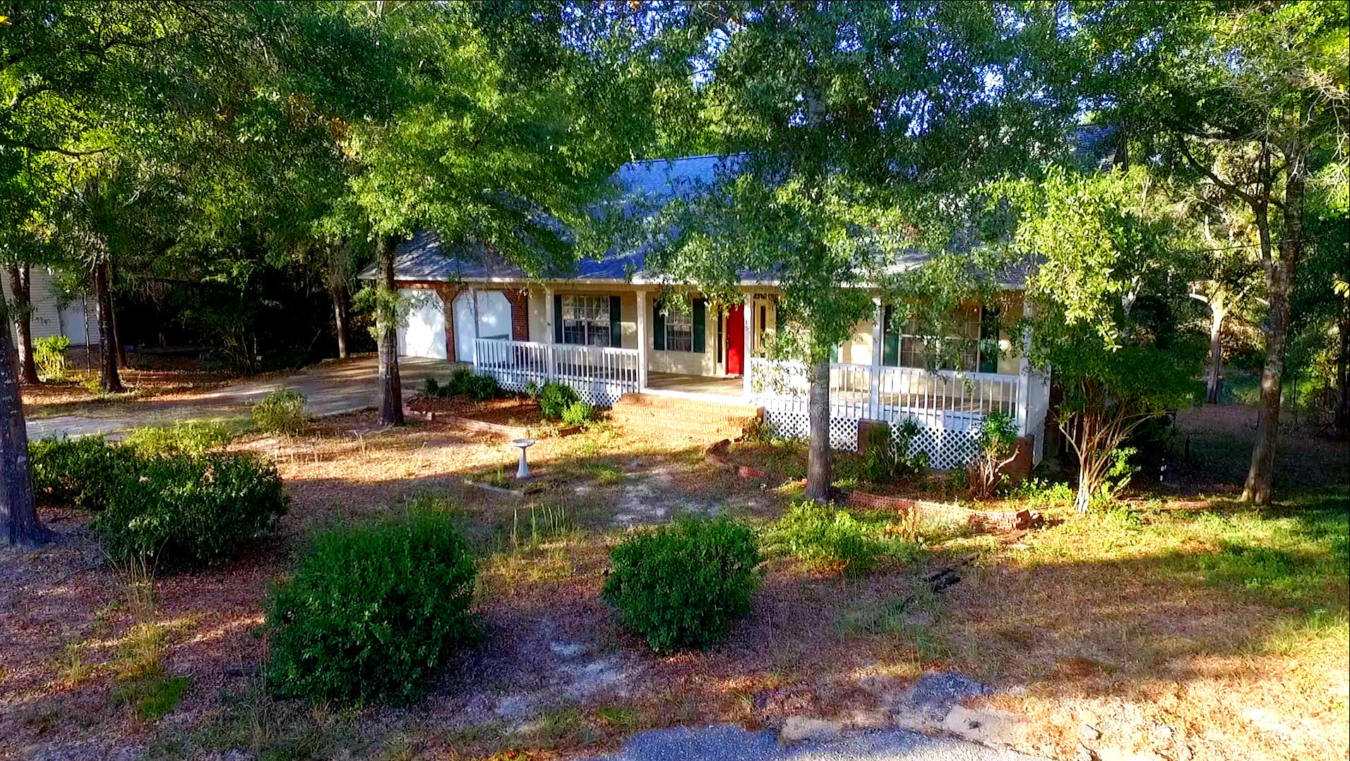 First floor is a walkout basement. Lakefront home. This is one to see!!! Beautiful home located on 2.25 acres with privacy and room to grow. Front porch across the front with upper and lower covered porches on the back , The living room has a fire place for the cozy nights, and room to entertain your friends and family. Beautiful 3/4'' solid oak floors in master bedroom & living room and cypress cathedral ceiling. Home has two master bedrooms and two kitchens . The downstairs has its own den with wood burning stove, kitchen, 3 bedrooms and 2 and 1/2 baths. Floors downstairs are laminate. The property has well water, and on septic. City water is available if wanted. Home has two AC units installed 3 years ago, and new roof. Also has a 1600 sqft shop with electricity.