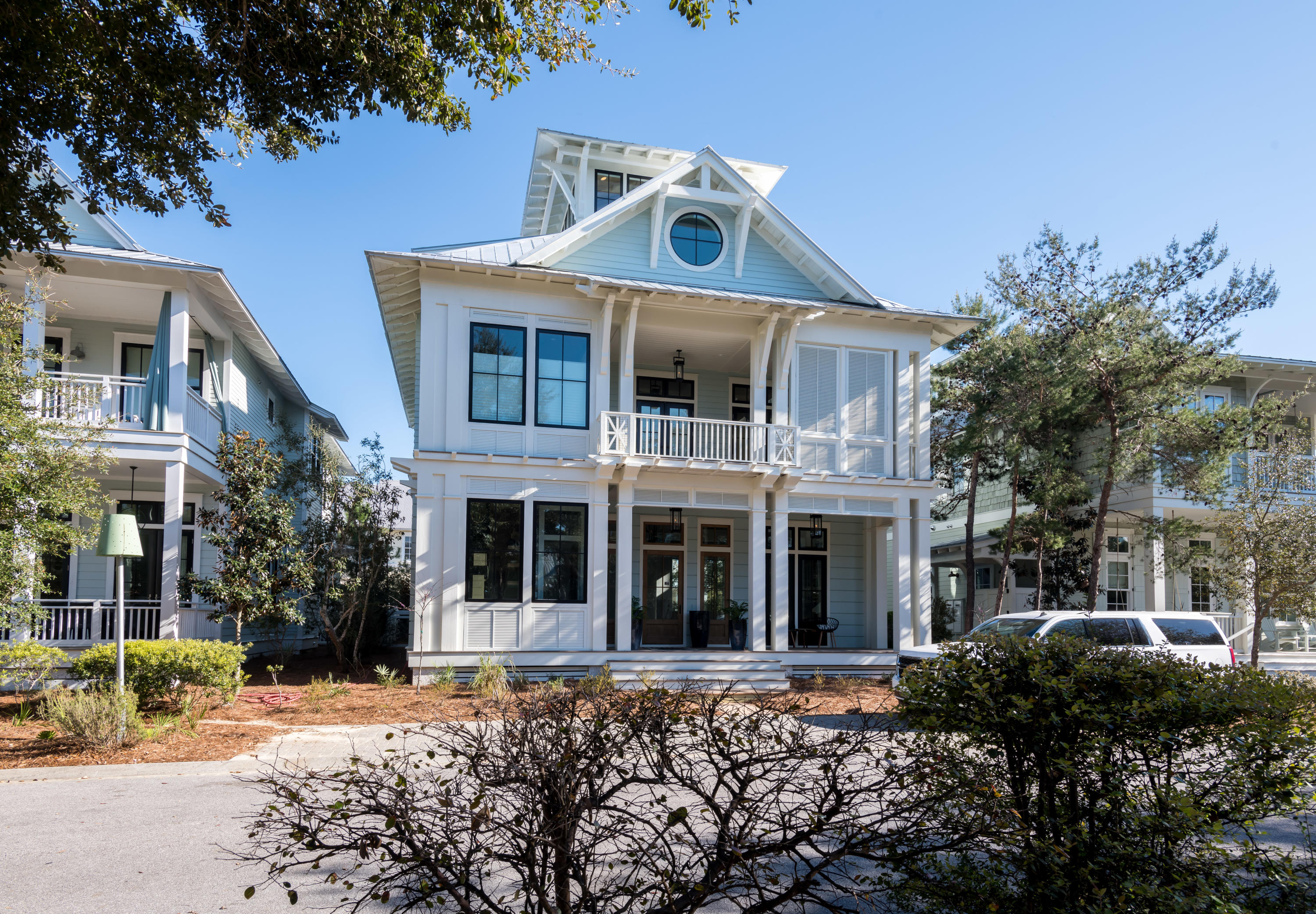 Sophisticated elegance meets traditional beauty in this expansive Watercolor, Florida masterpiece, designed by T.S. Adams and built by renowned builder Borges-Brooks Construction. Throughout this grand coastal home are exquisite reclaimed oak floors, doors, and cabinet facings soothe the eye with natural beauty, while meticulously curated tile, fixtures, and accessories provide pops of modernity in just the right proportion. The main living areas of the home are on the ground floor, which encompasses the living and dining areas plus the kitchen with large butler's pantry. High-design, custom cabinetry in the butler's pantry touts impressive and sleek storage. A collapsible glass wall opens to the outdoor kitchen and pool with s