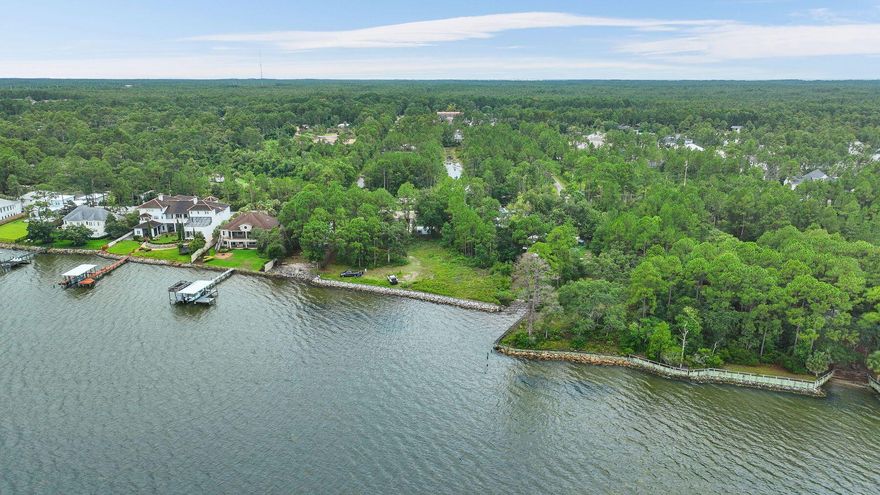 Rare opportunity to own 145 linear feet of Bay Frontage just west of 331 in a setting that has been crafted to create a beautiful estate compound.A substantial single family lot can be used creatively to imagine a large estate home on one lot, and with the financed purchase of the adjacent lot one can complete an additional single family home or 'kids' house, pool and three car garage on the other.  With the opportunity to have two docks or two of everything, even one who wants to develop two fine homes should explore this setting.With the purchase of this, the owner will finance the other lot for a limited time interest only so that you can preserve capital while you image your creations on this setting.  Access easement of 20' in a flag orientation is provided in perpetuity.