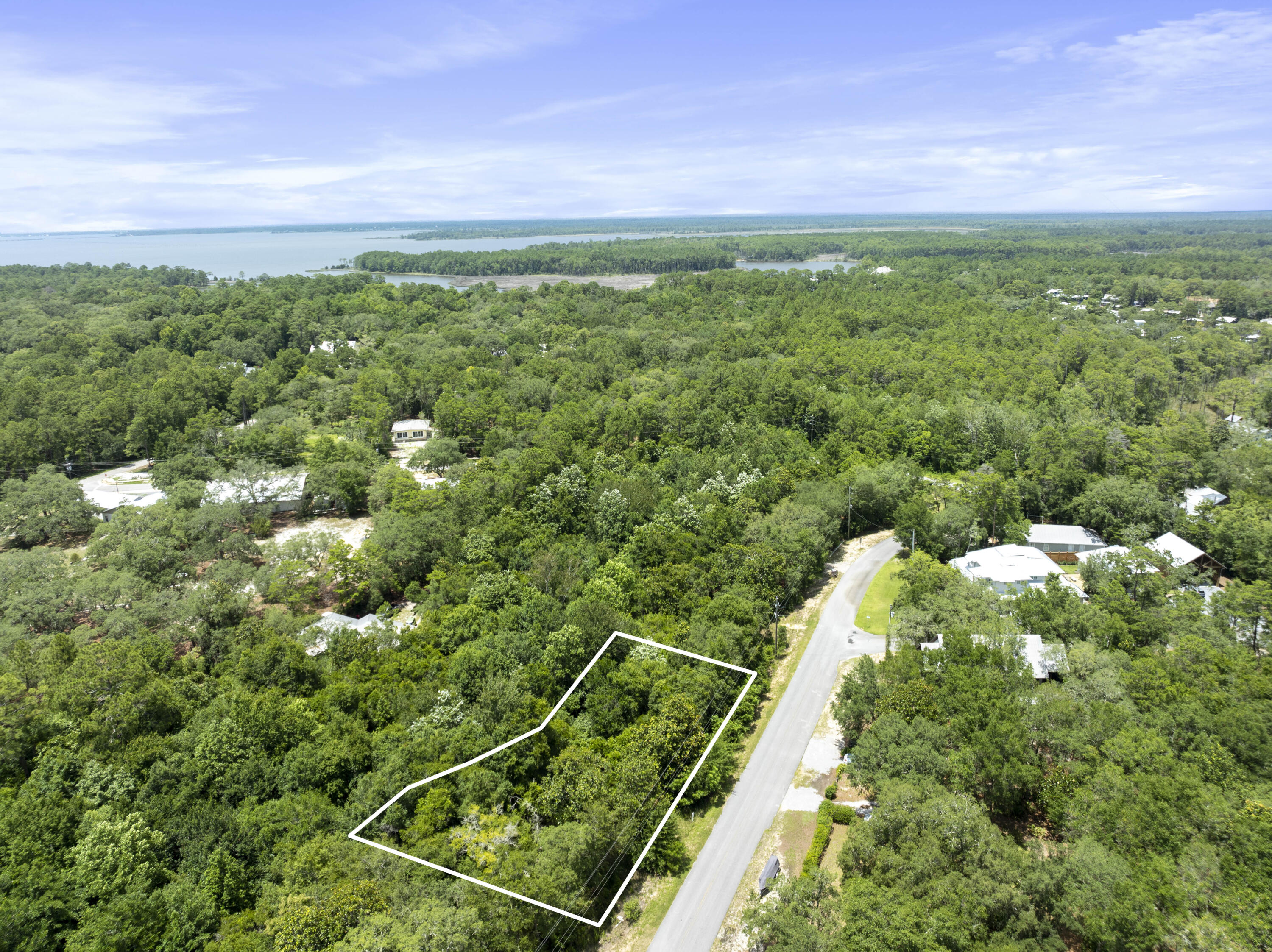 Located in the heart of Point Washington - one of the most desirable areas in Santa Rosa Beach this homesite offers the perfect blend of tranquility and accessibility. Nestled on a quiet street near the bay, the property is just a short walk or bike ride to Eden Gardens State Park. Head south on Highway 395 and you'll find yourself in the heart of Seagrove and the stunning beaches of South Walton within minutes. Enjoy peaceful surroundings while staying close to the vibrant lifestyle and amenities of 30A. This lot comes with house plans and layout that have been approved by FL DEP and COE. Outline in photos is not exact and only meant to be a general guide as to the location of property lines. Please do not walk on the neighboring lots as they are owned by homeowners.