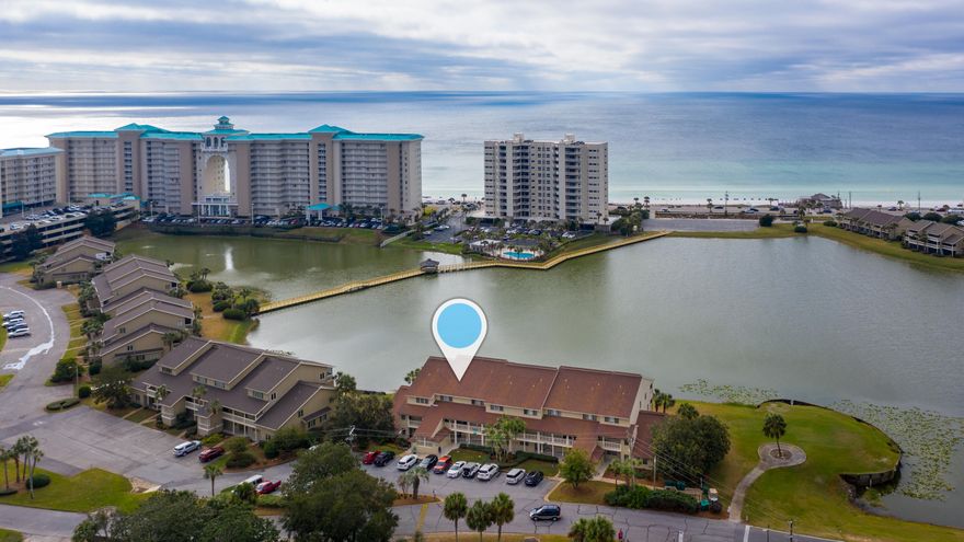 Getaway to the balcony to enjoy the warm sun sparkling on tranquil Stewart lake and the beautiful Gulf of Mexico!  This beach-inspired, lake-front condo features renovated baths & kitchen, tile flooring, fresh paint, upgraded lighting, cozy furniture, crown-molding & new appliances-including washer & dryer!  Kitchen highlights include large island, granite countertops, white, Shaker-style cabinetry, tile backsplash, smooth ceilings & recessed lighting! Each bath totally updated!  The balcony porch-swing is sure to be a favorite with family & guests! Storage unit! Just a short walk to the Whale's Tail, Royal Palm Grille & the beach! Community pool close by!  Unit has never been rented-pristine condition!