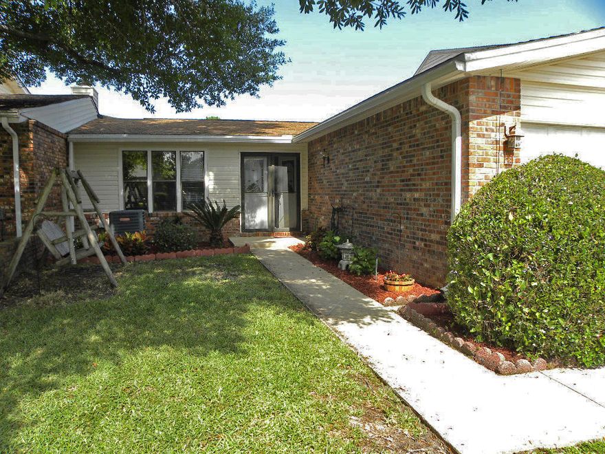 THE SIMPLE LIFE: JUST MINUTES TO EVERYTHING! You'll love the easy lifestyle of this sunny Florida-style home with two huge bedrooms and two full baths and a fantastic open floor plan. Spacious living area with brick fireplace (seller had it sealed years ago) and custom cabinets with bookshelves on each side. Large dining area perfect for dinner parties or entertaining large groups. Kitchen has a skylight for natural light, lots of cabinets to include built-in shelves for your cookbooks, pantry and plenty of counter space. The home revolves around a delightful Florida room that makes another separate living area great for your flat screen tv and a office area. There is a door that leads out to a small patio which is just the right size for your grill and a bistro table and chairs.