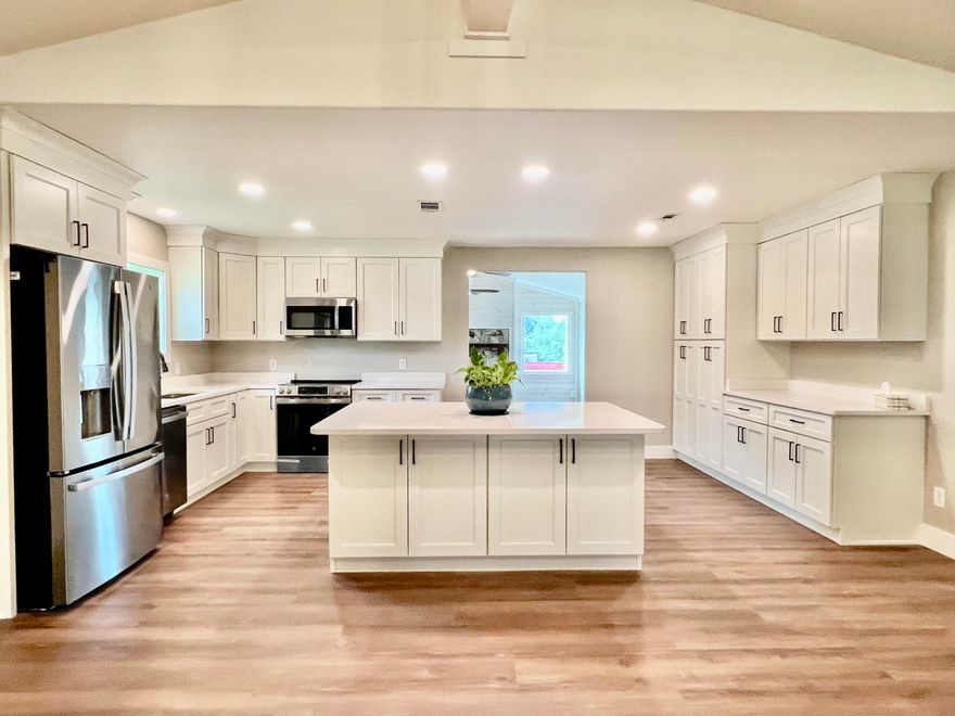 Welcome to a beautifully reimagined home--fresh, bright, and fully transformed from top to bottom. Open concept design great for large family gatherings, entertaining, and even a little dancing.  This gorgeous home features a magnificent chef's kitchen with an impressive island, quartz countertops, plenty of cabinetry, bar seating, and brand-new appliances--including refrigerator.  A gas fireplace greets you in the front family room, just off the courtyard entry, with beautiful large windows.  Spacious master suite with walk-in closet and stunning bath. LVP flooring throughout, large laundry/utility room, and oversized 2-car garage with keypad. New roof, HVAC, hot water heater, and more! Huge corner lot with a charming courtyard and a storage building. Owner Finance and commercial potential