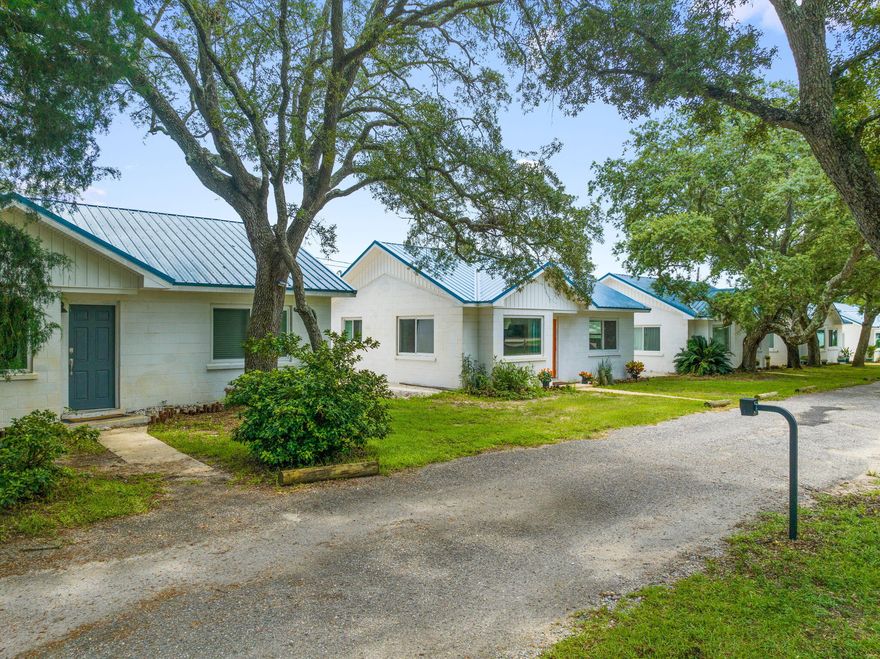 ***INVESTOR ALERT***Now on the market is one of the most unique waterfront properties in Navarre.  Over 2 acres on the sound with 229 feet of sandy beach, high and dry flat level lot, vast majority of the property is in flood zone X.  This investment property has a 1701 square foot main home on the water with SIX additional 2 bedroom/1 bath 738 sqft renovated fully furnished cottages that provide instant income.  You will not find many properties like this on the Florida Panhandle.  The wonderfully remodeled concrete block cottages at this gated property are currently rented through AirBnB.  The property also features plenty of room for parking RVs, beautiful live oaks, breathtaking water views, and so much more.  This property has gone through an extensive remodel and overhaul.  Some of the improvements include: Brand new lift station serving the 6 cottages, full new plumbing work and fixtures, walk in showers added, new sewer line into the cottages, all new wiring including panels and meters, roofs and trusses replaced, HVAC systems, impact windows, luxury vinyl floors, quartz countertops, appliances, the list goes on and on.  Last year rental income was $145k with four of the cottages renovated, now all six of the are completed and now being rented.  Currently the owner does not do same day turnovers and does not rent during the winter months so more rental income could be generated.  The main home could also be rented out, lived in, or provide housing for an onsite manager.  Properties like this simply do not come around very often!