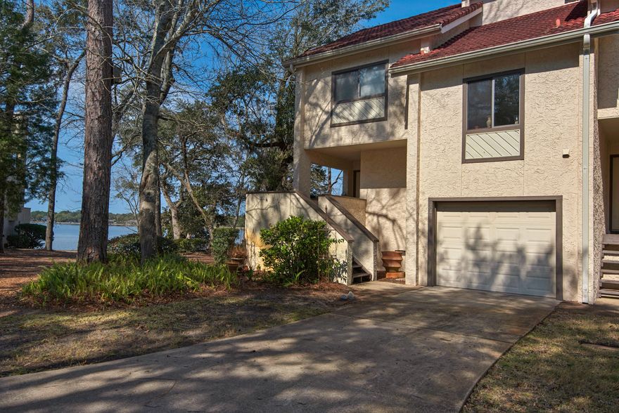 Completely remodeled waterfront townhome in a peaceful serene setting. A 2015 remodel included all new cabinetry, granite countertops, kitchen and bath fixtures. A new tiled master shower. New glass doors in master and guest bath. New light fixtures throughout. New interior doors and base boards. New toilets. New paint. New electric fireplace and wall tiles. End unit location provides lots of glass and privacy. Located adjacent to a parklike common area. Enjoy beautiful sunsets, dolphin and bird watching all from your windows and outside deck.